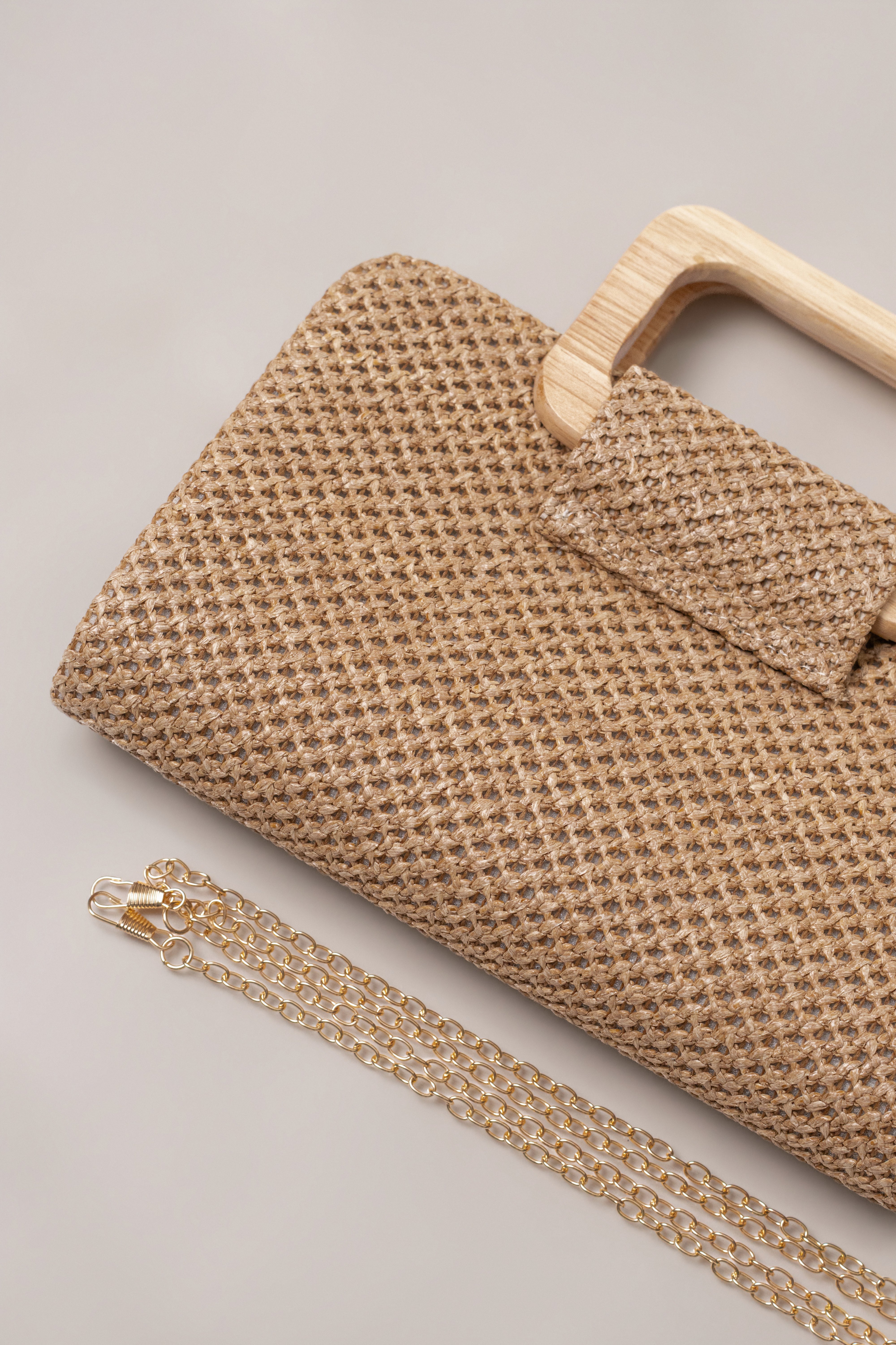 Brown driftwood clutch bag by JLUXLABEL, featuring textured wood design and compact accessory style for stylish occasions.
