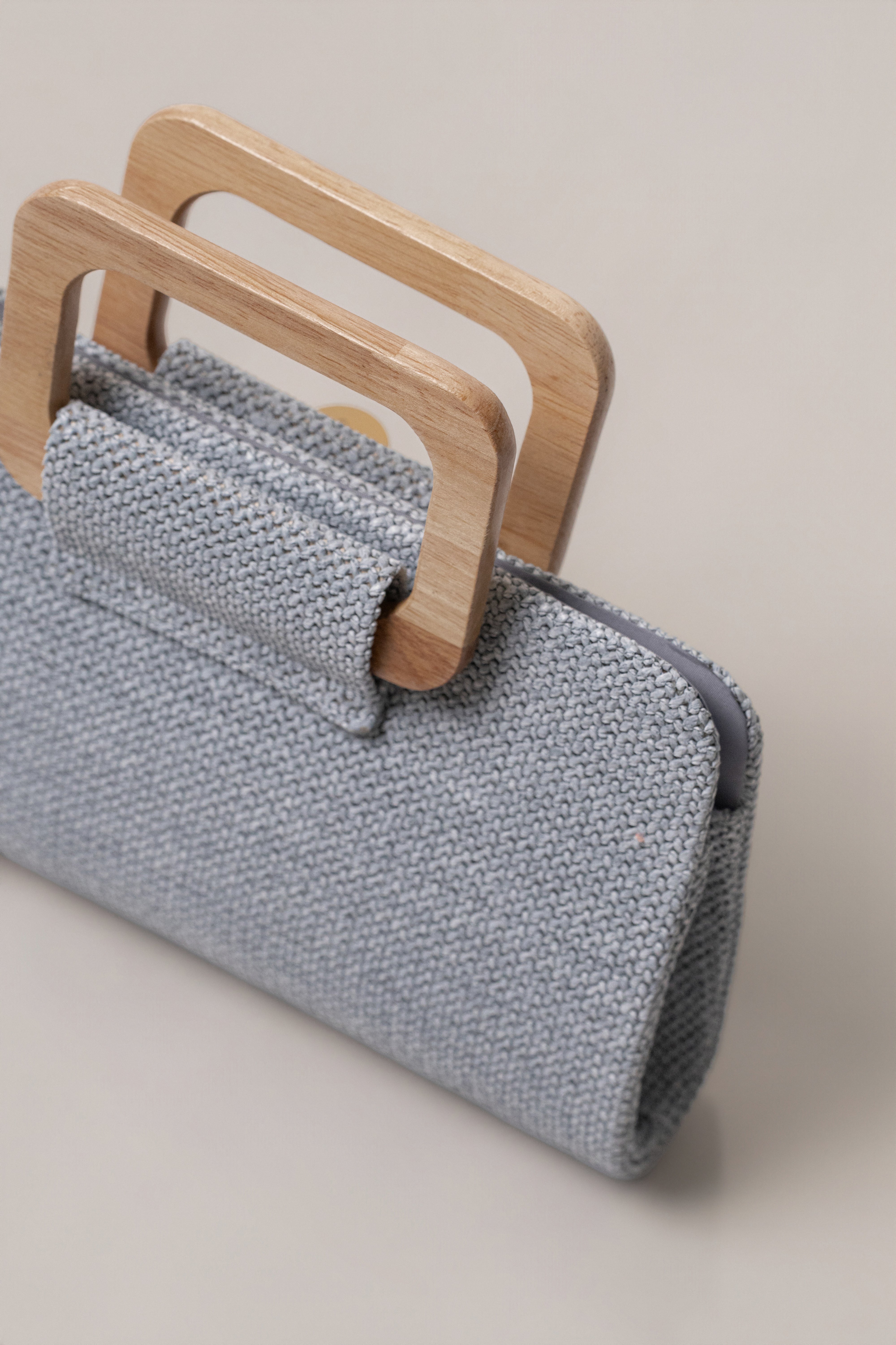 Blue Isola clutch by JLUXLABEL featuring a sleek design and compact size, perfect for accessories and evening occasions.