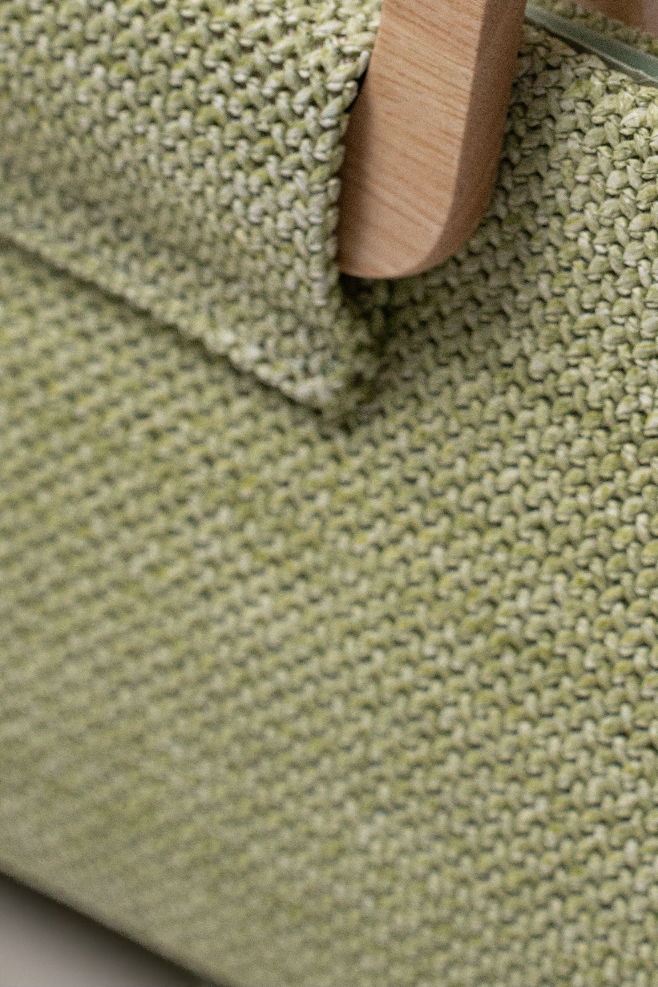 Sage Isola clutch by JLUXLABEL, a stylish accessories bag with a sleek design and textured finish.