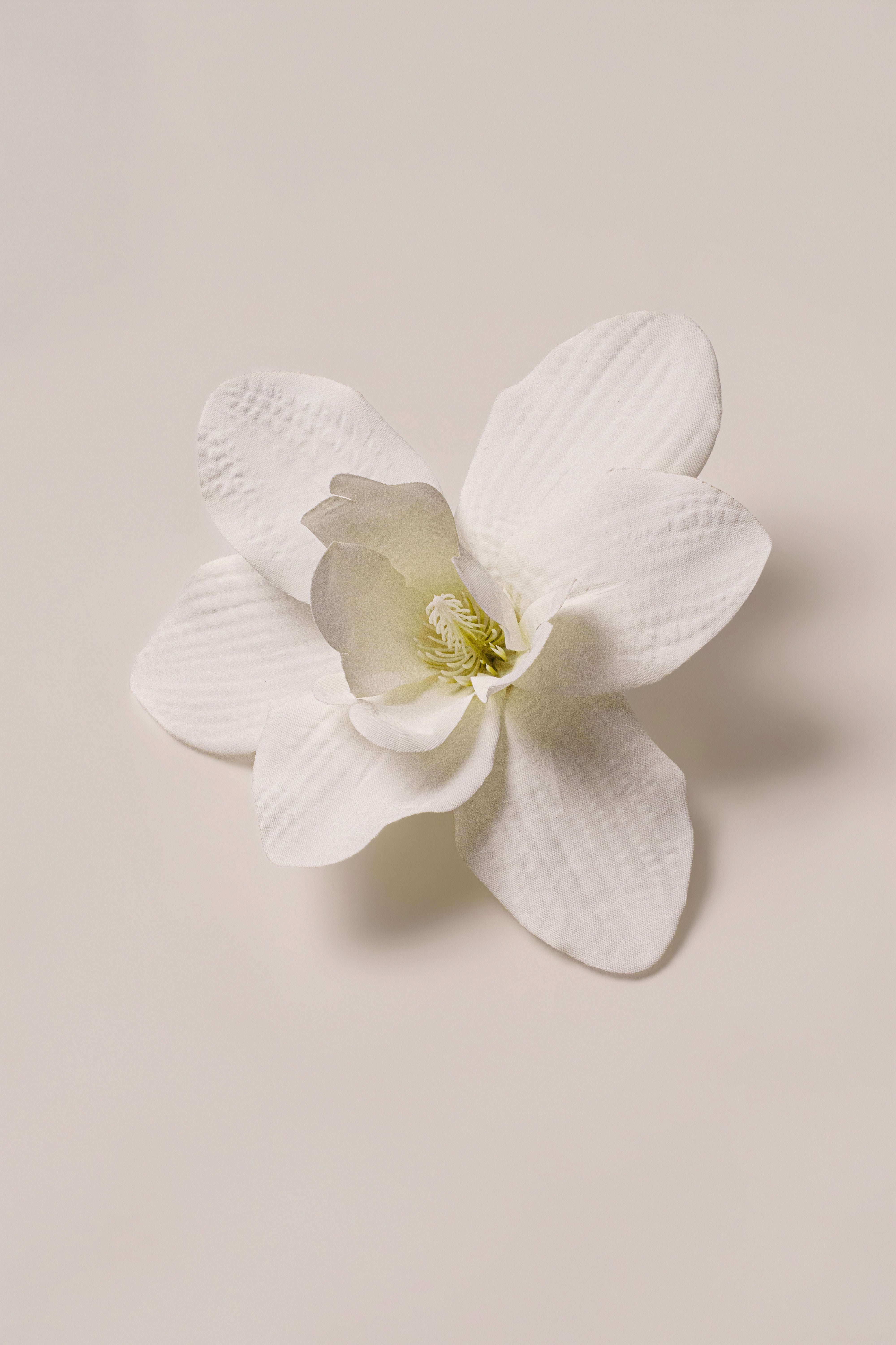 White coastal orchid hair clip by JLUXLABEL, stylish accessory with a delicate floral design for hair embellishment.