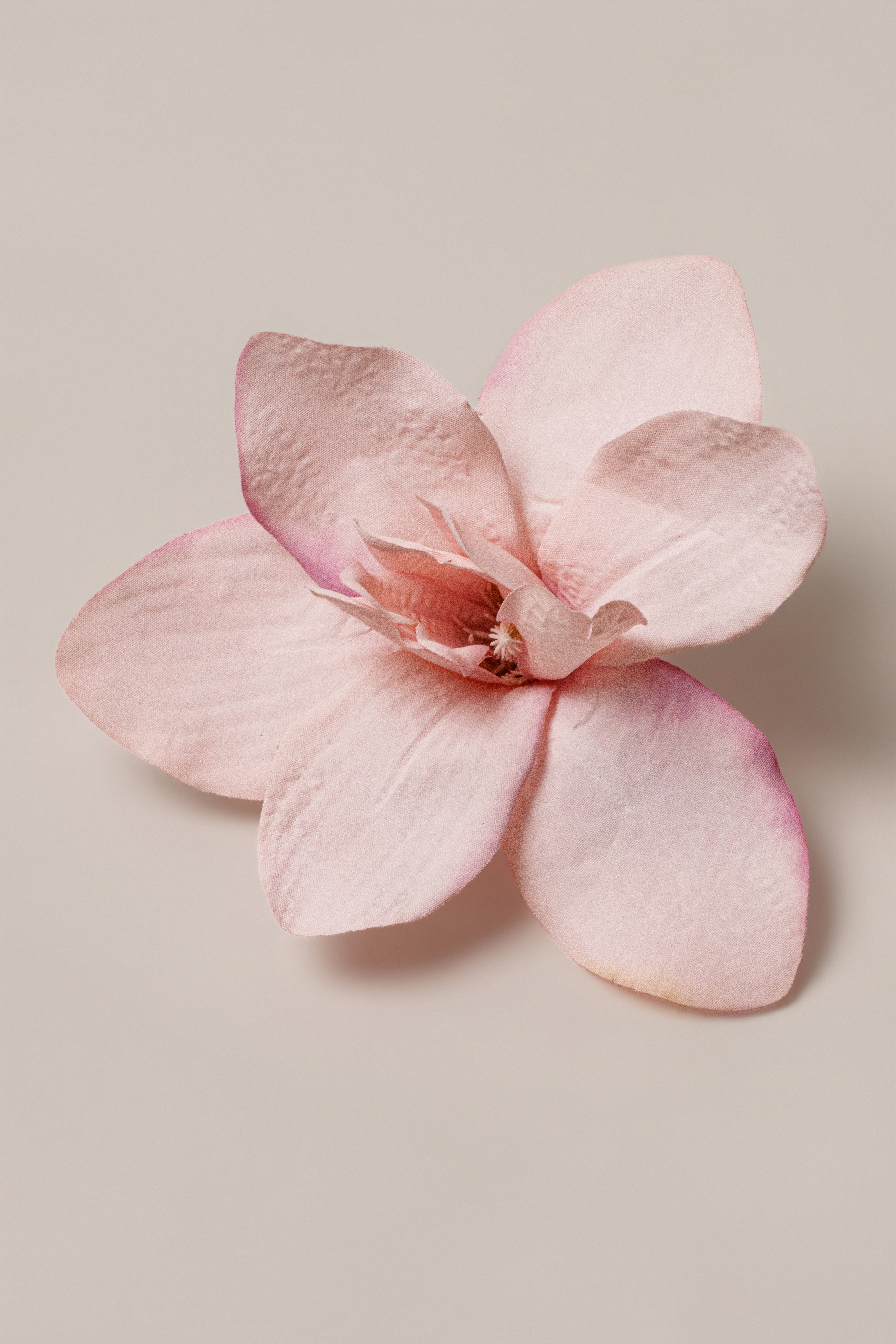 Light pink coastal orchid hair clip by JLUXLABEL, showcasing floral design and sleek accessory style.