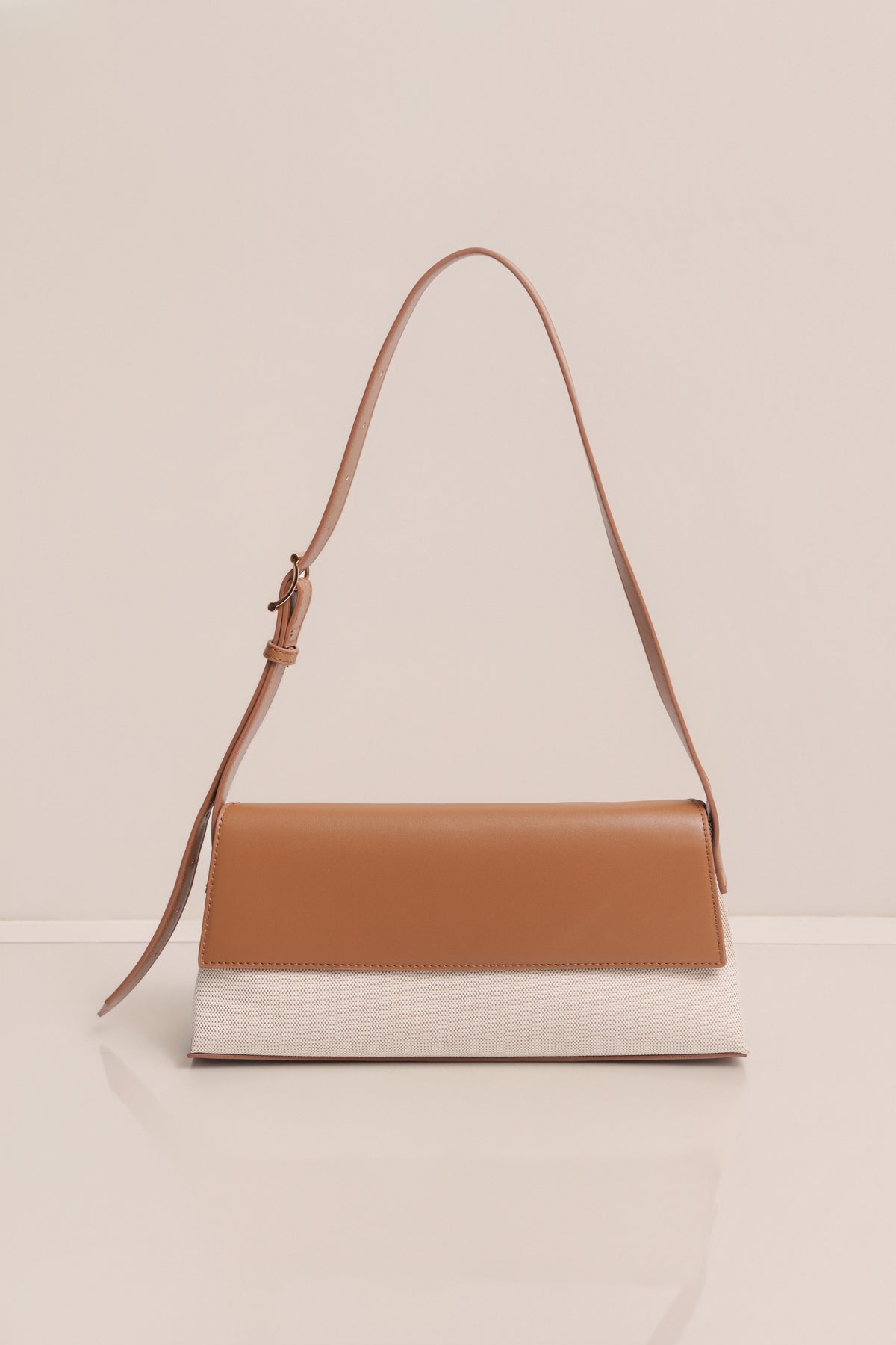 Beige JLUXLABEL Hudson shoulder bag with shoulder strap and minimalist design, perfect for accessories and casual styling.