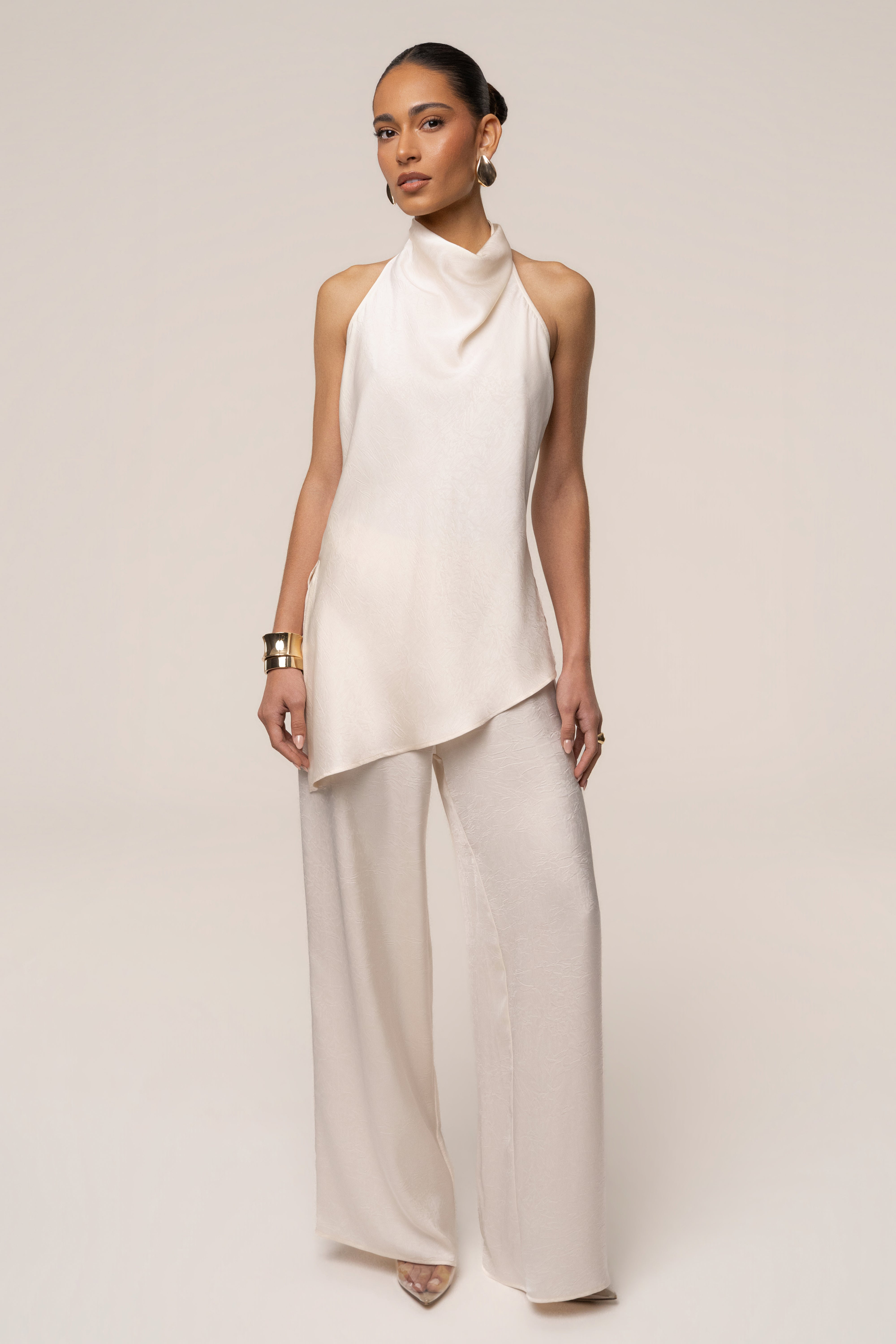 Cream satin pant set with draped design from JLUXLABEL, featuring wide-leg pants and a matching sleeveless top.