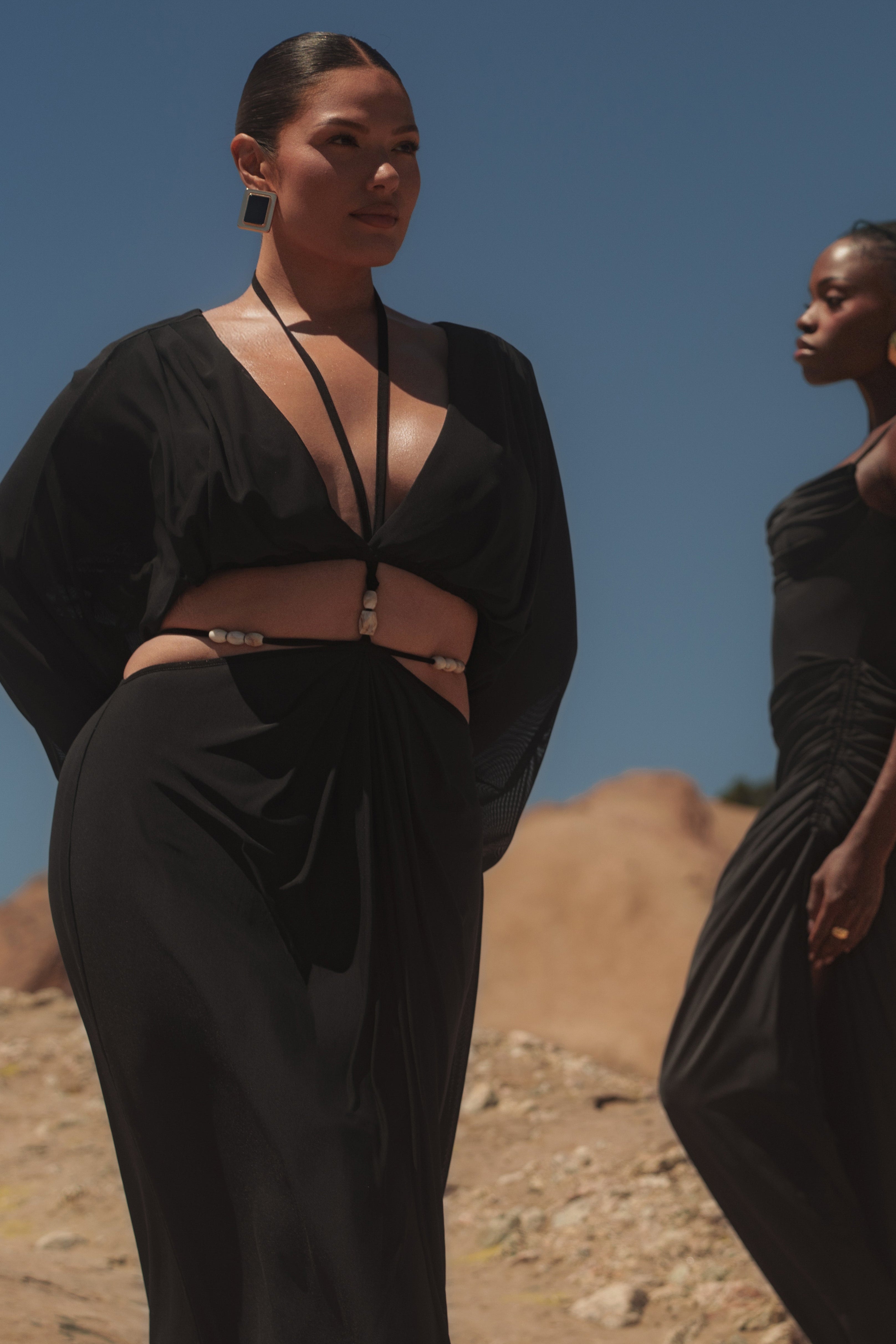 Black Hera Draped Maxi Skirt by JLUXLABEL, flowing black bottom with elegant draped design, shown on a model.
