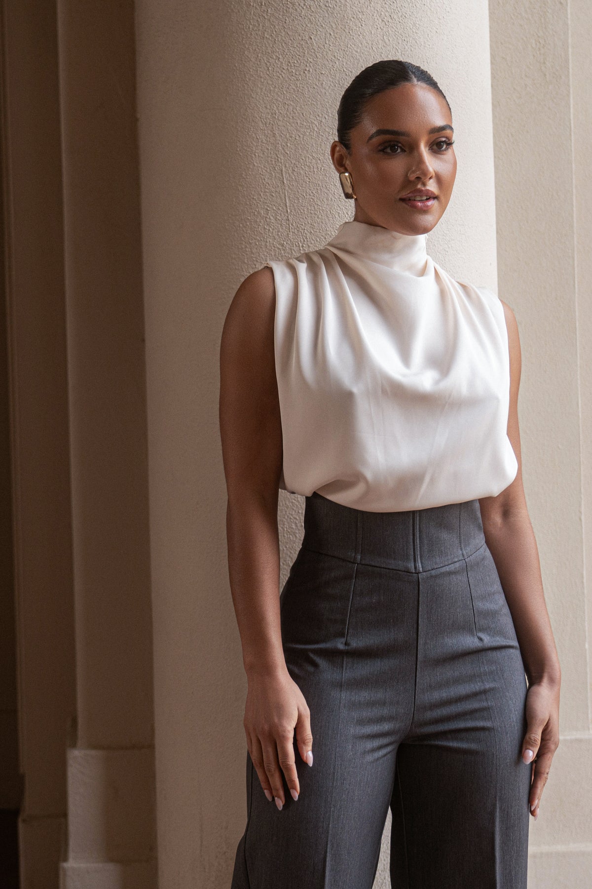 JLUXLABEL Buttercream Desiree mock neck top displayed on a model, showcasing its fitted design and soft fabric.