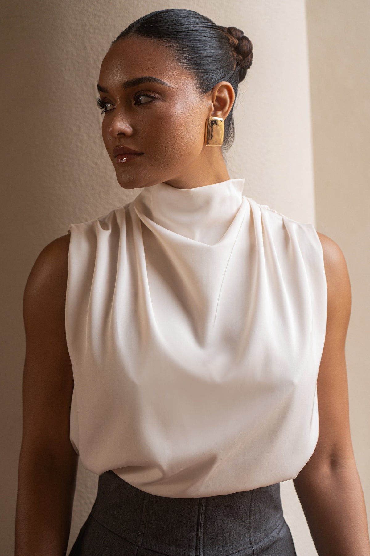 JLUXLABEL Buttercream Desiree mock neck top, soft fabric and fitted design, shown on a model in a stylish casual setting.