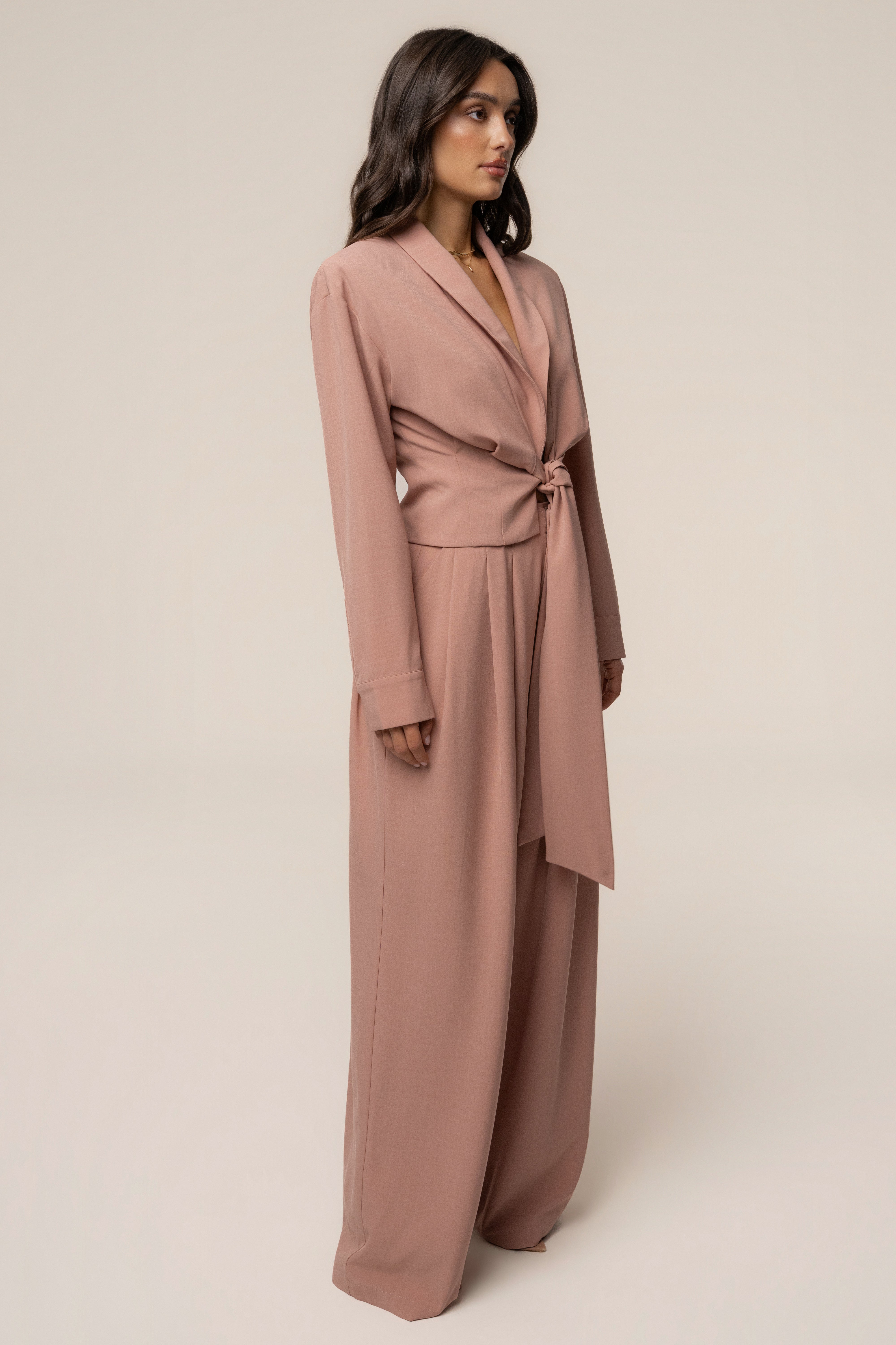 Mauve JLUXLABEL wrap top with long sleeves and V-neck, styled on a mannequin. Elegant women's fashion top.