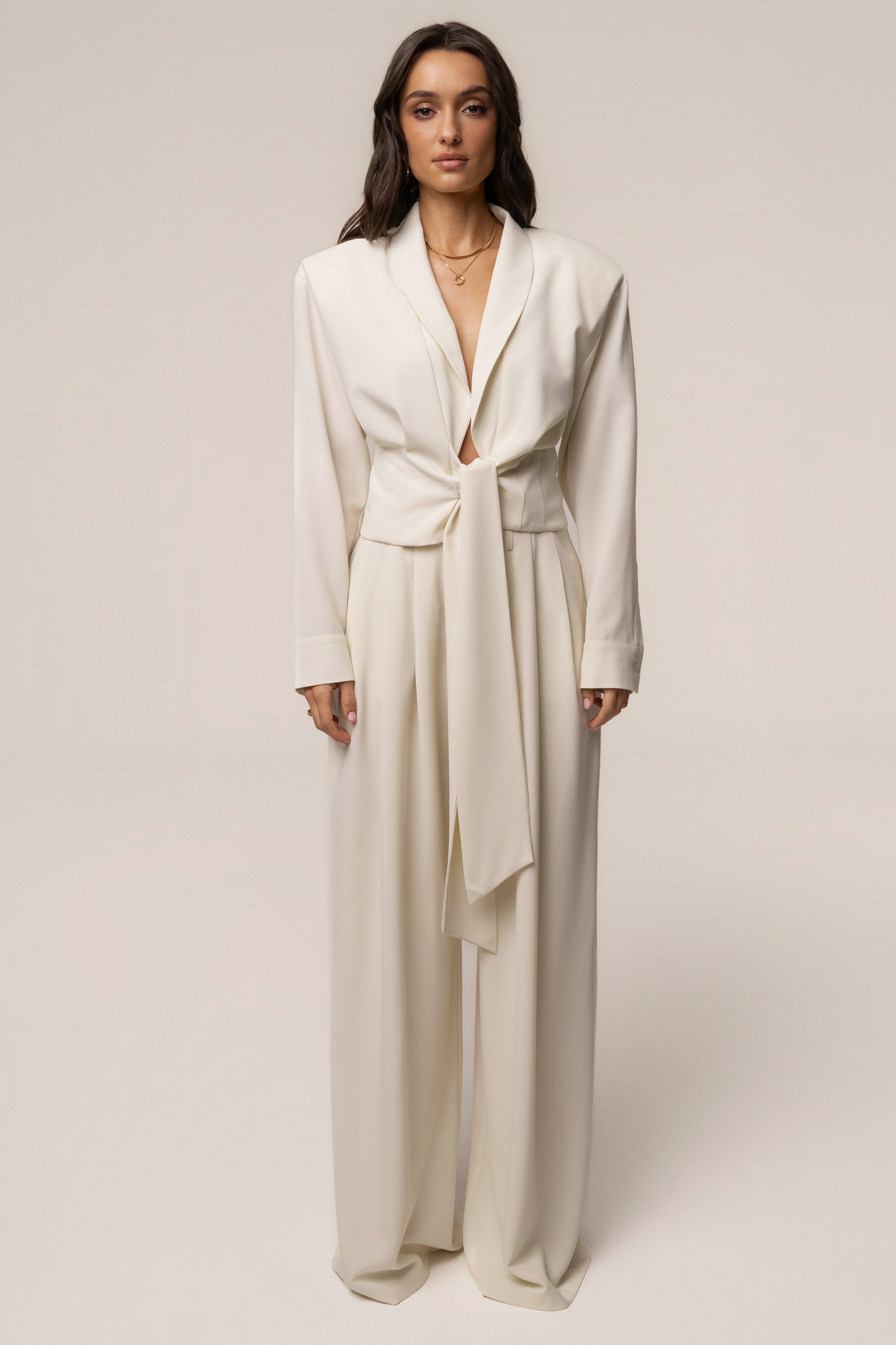 Cream Estate Pleated Trouser from JLUXLABEL, stylish bottoms with a tailored fit and pleated design, shown on a model.