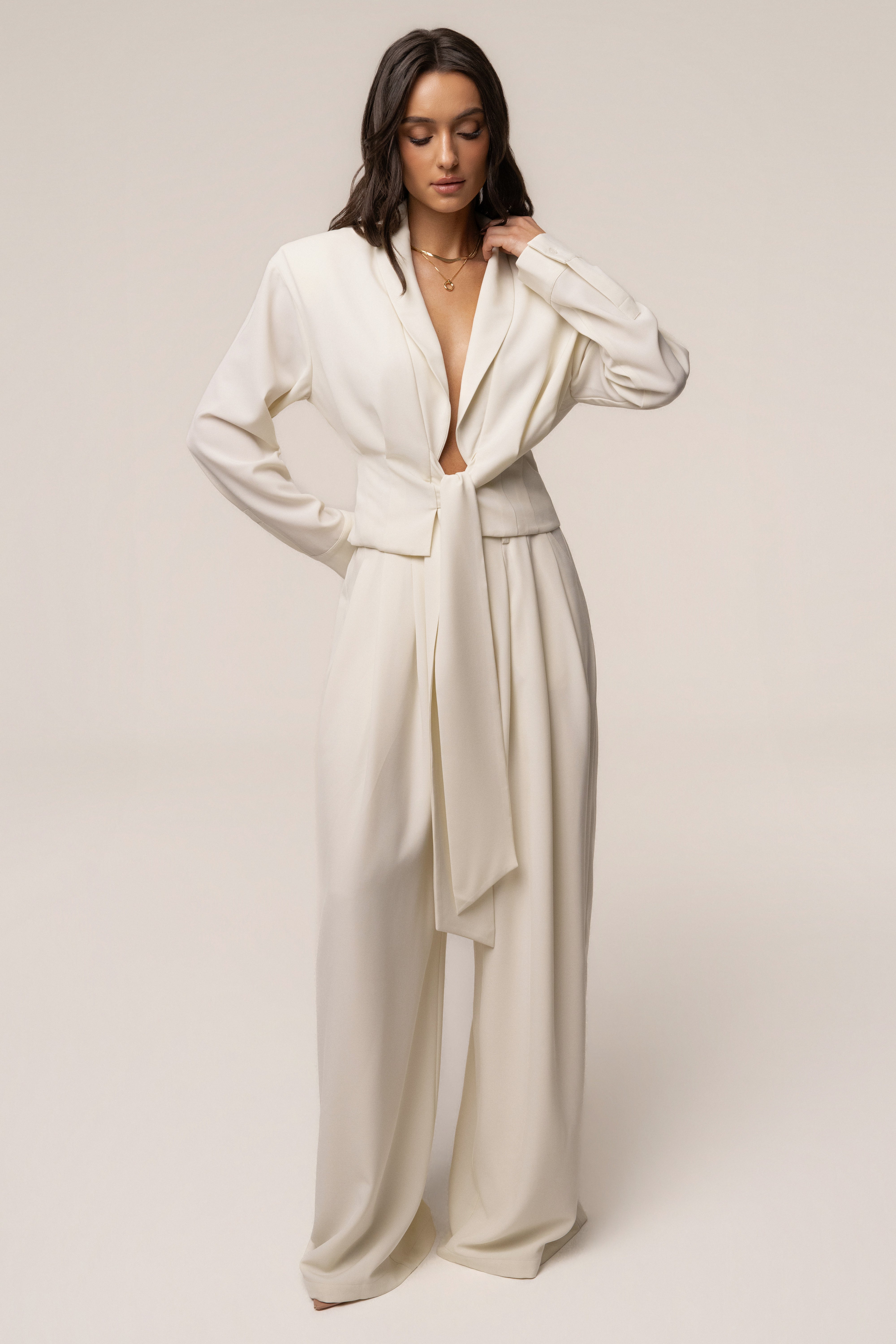 Cream Estate Pleated Trouser by JLUXLABEL, stylish pleated bottoms with a tailored fit, shown on a model.