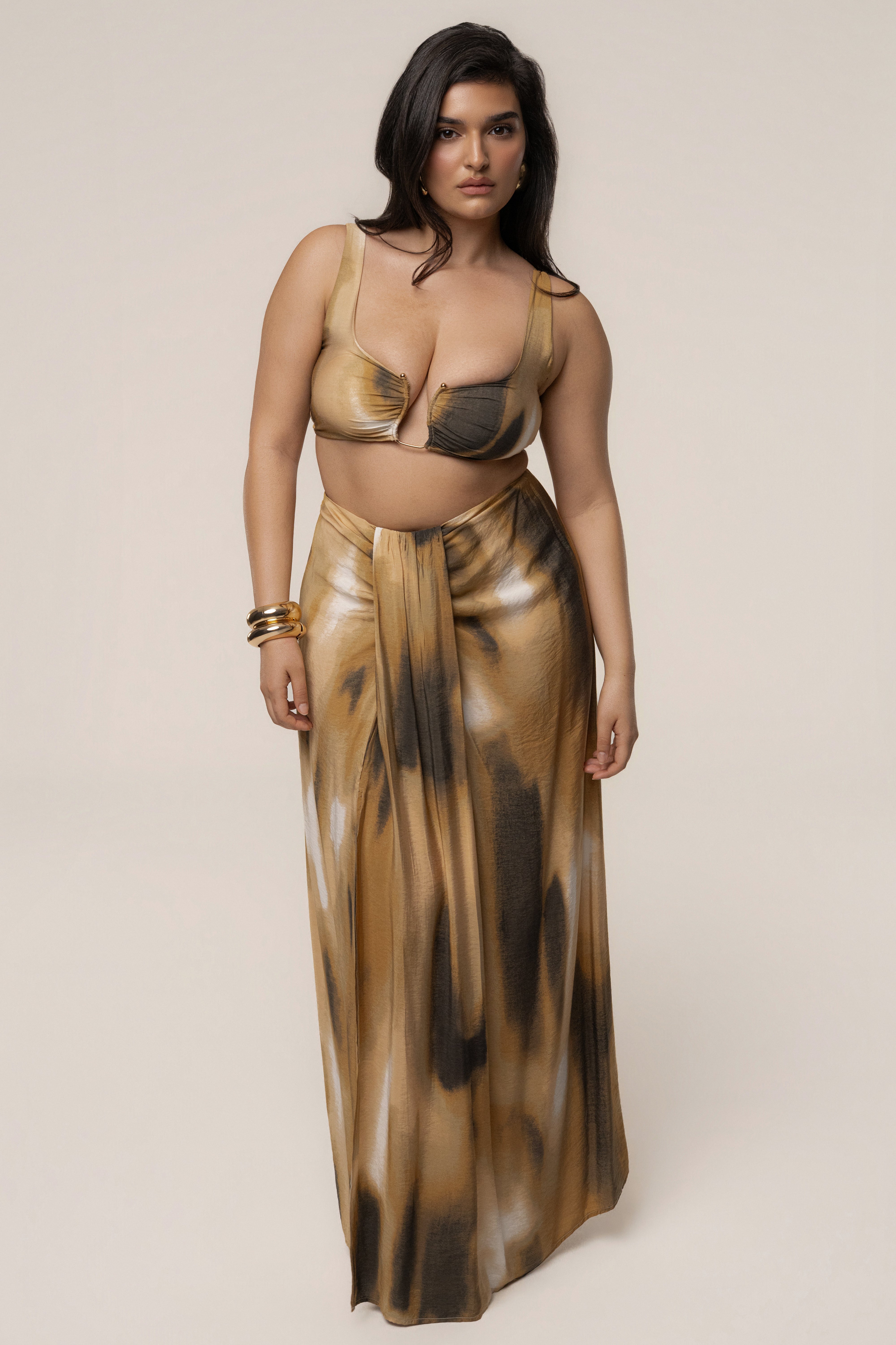 Brown flowing maxi skirt from JLUXLABEL featuring a relaxed fit and elegant drape, styled with a casual top.