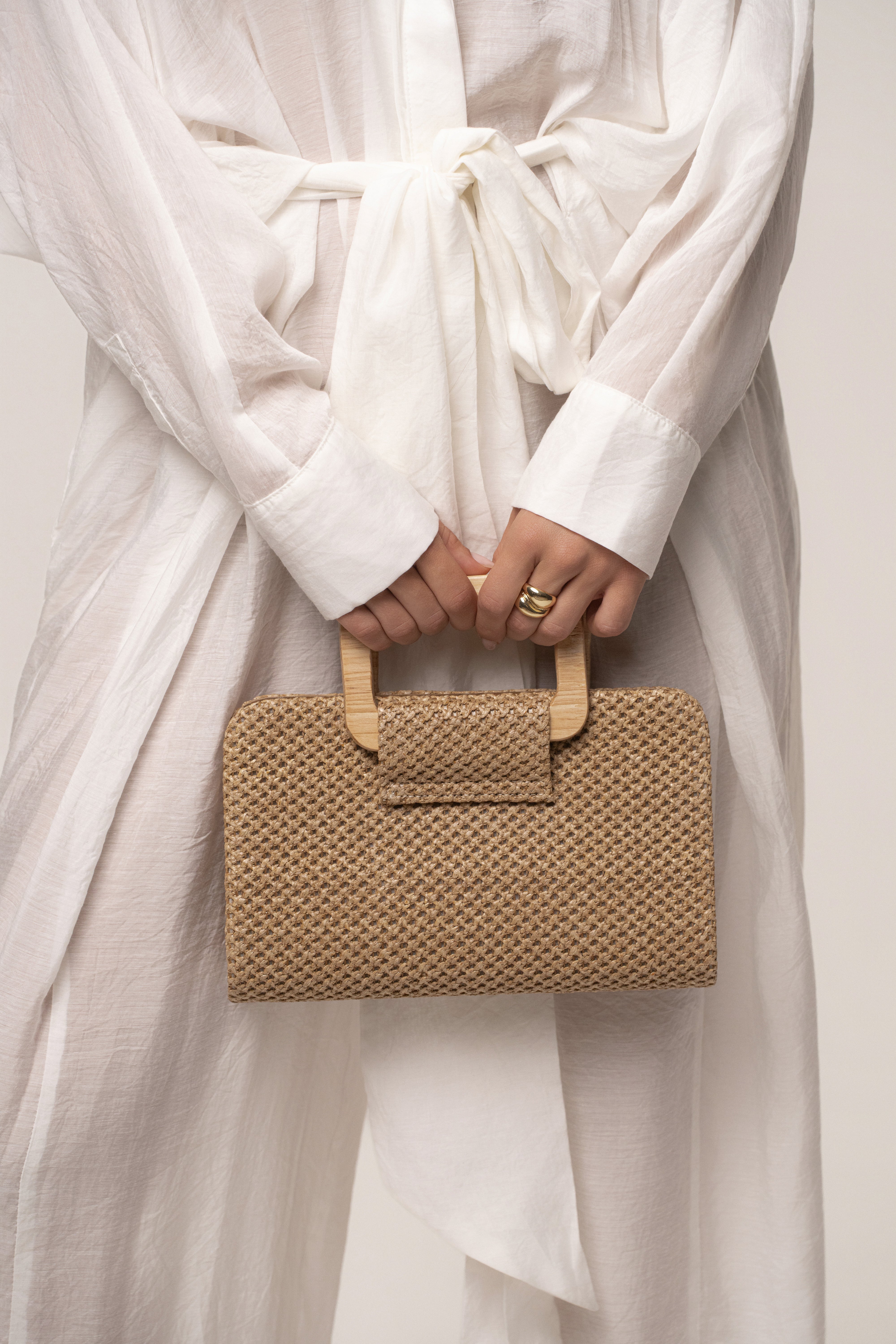 Brown driftwood clutch bag by JLUXLABEL, made of textured wood-like material, with a sleek, minimalist design for accessories.