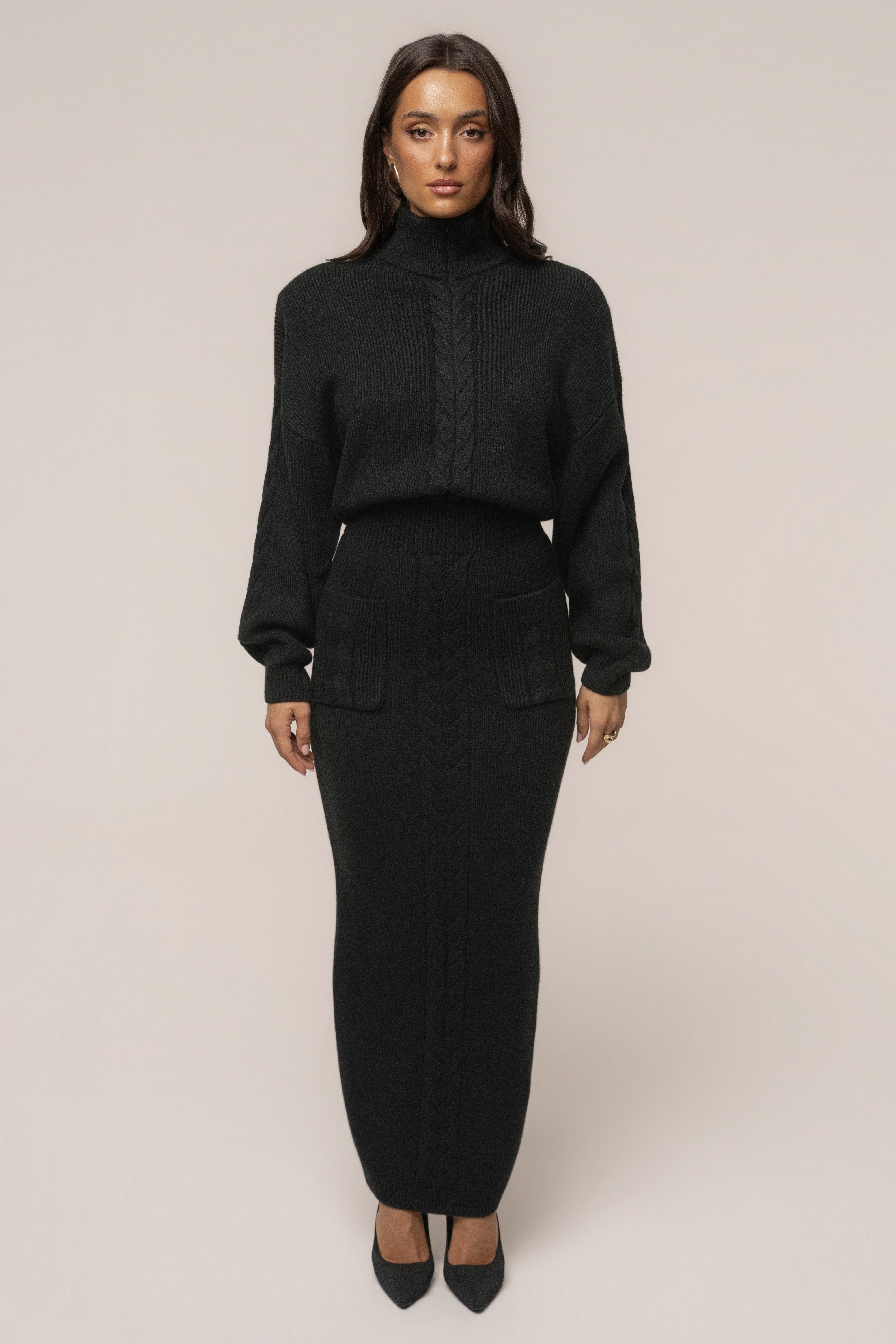 Black ribbed dress by JLUXLABEL featuring a cozy, fitted design perfect for casual or stylish occasions.