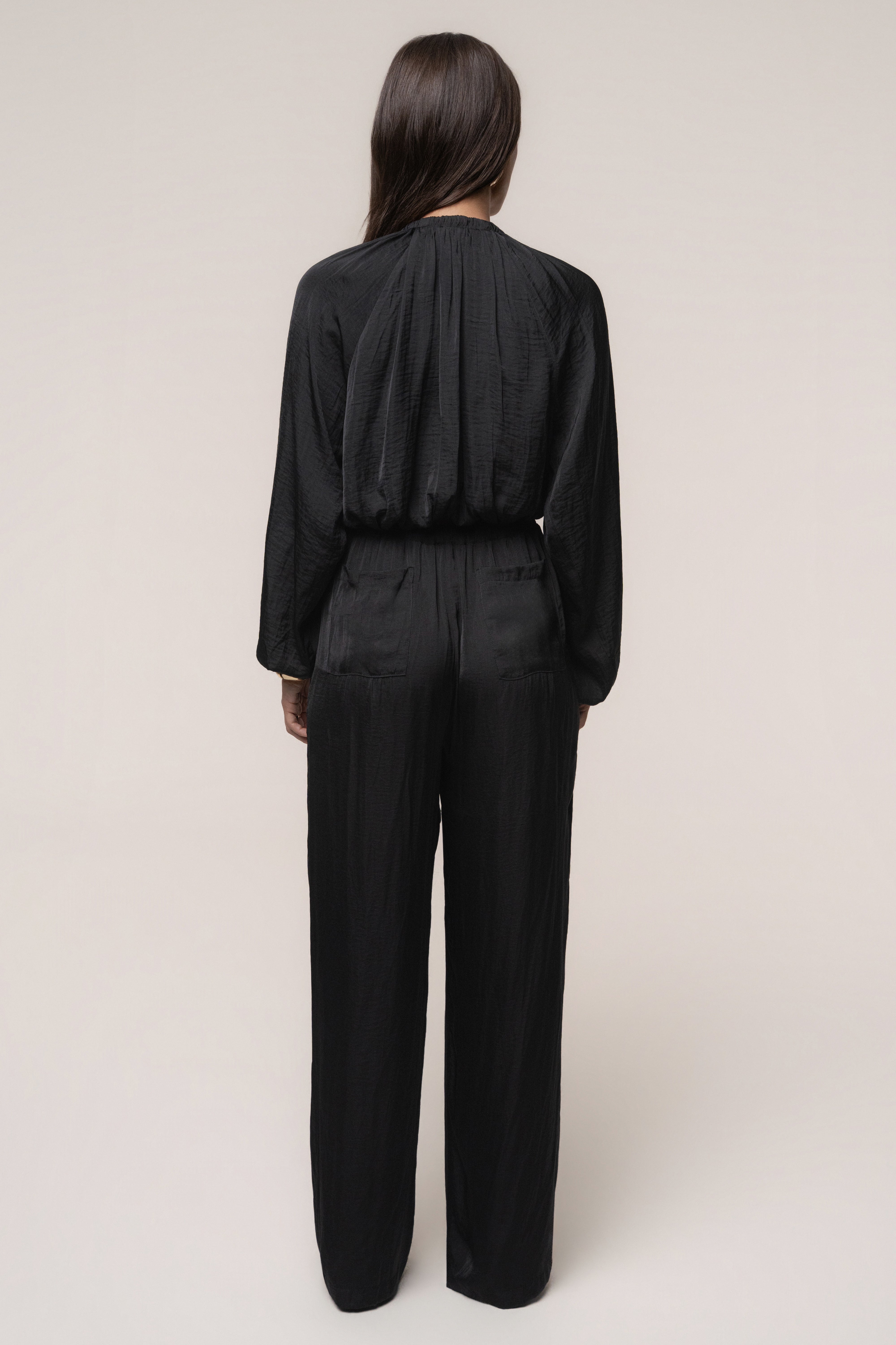 Black Seaside Glow top by JLUXLABEL, featuring a stylish design, worn by a model showcasing its fit and fabric details.
