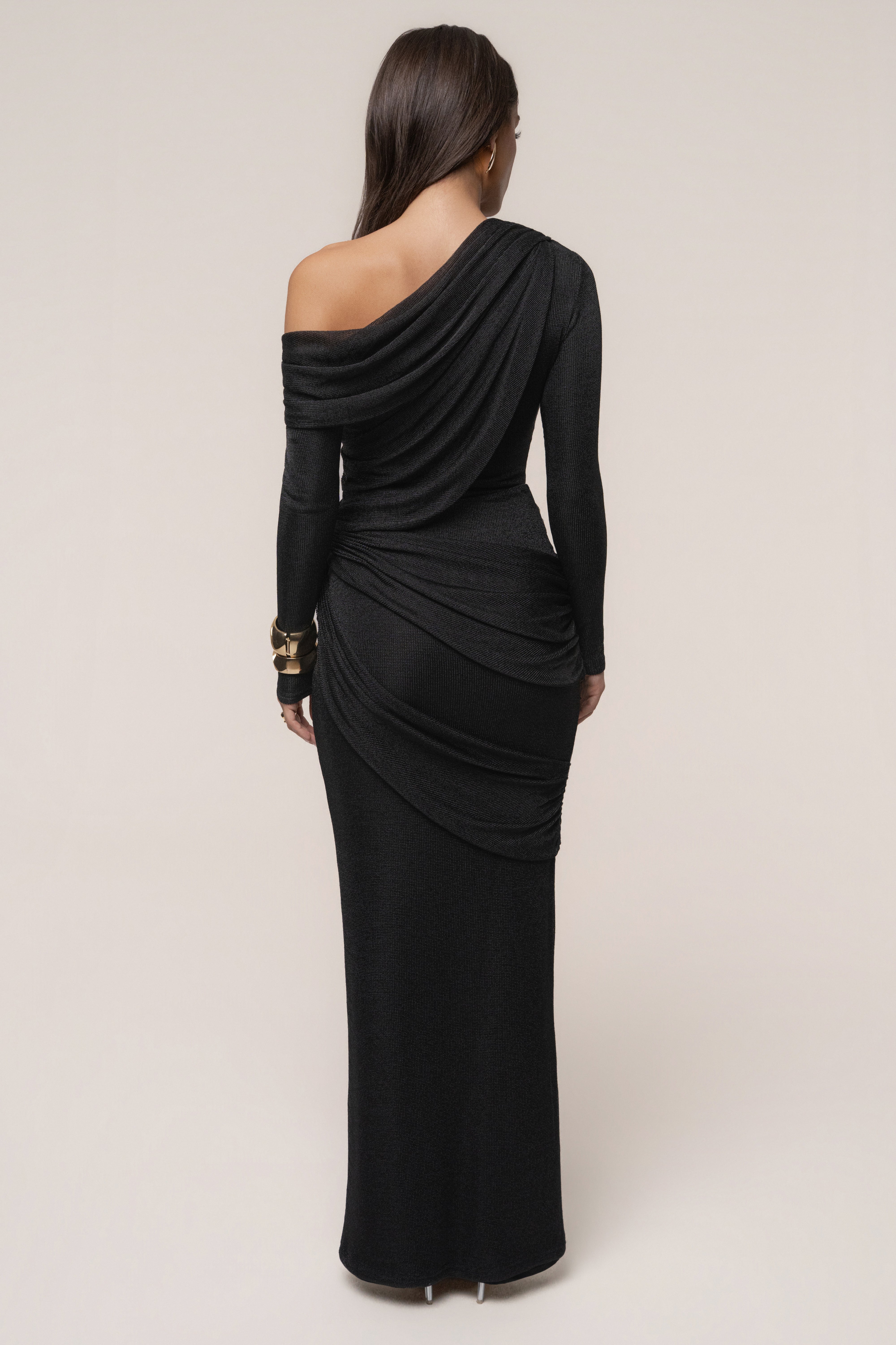 Black metallic bodysuit from JLUXLABEL featuring a sleek, opulent design with metallic fabric, long sleeves, and a fitted silhouette.