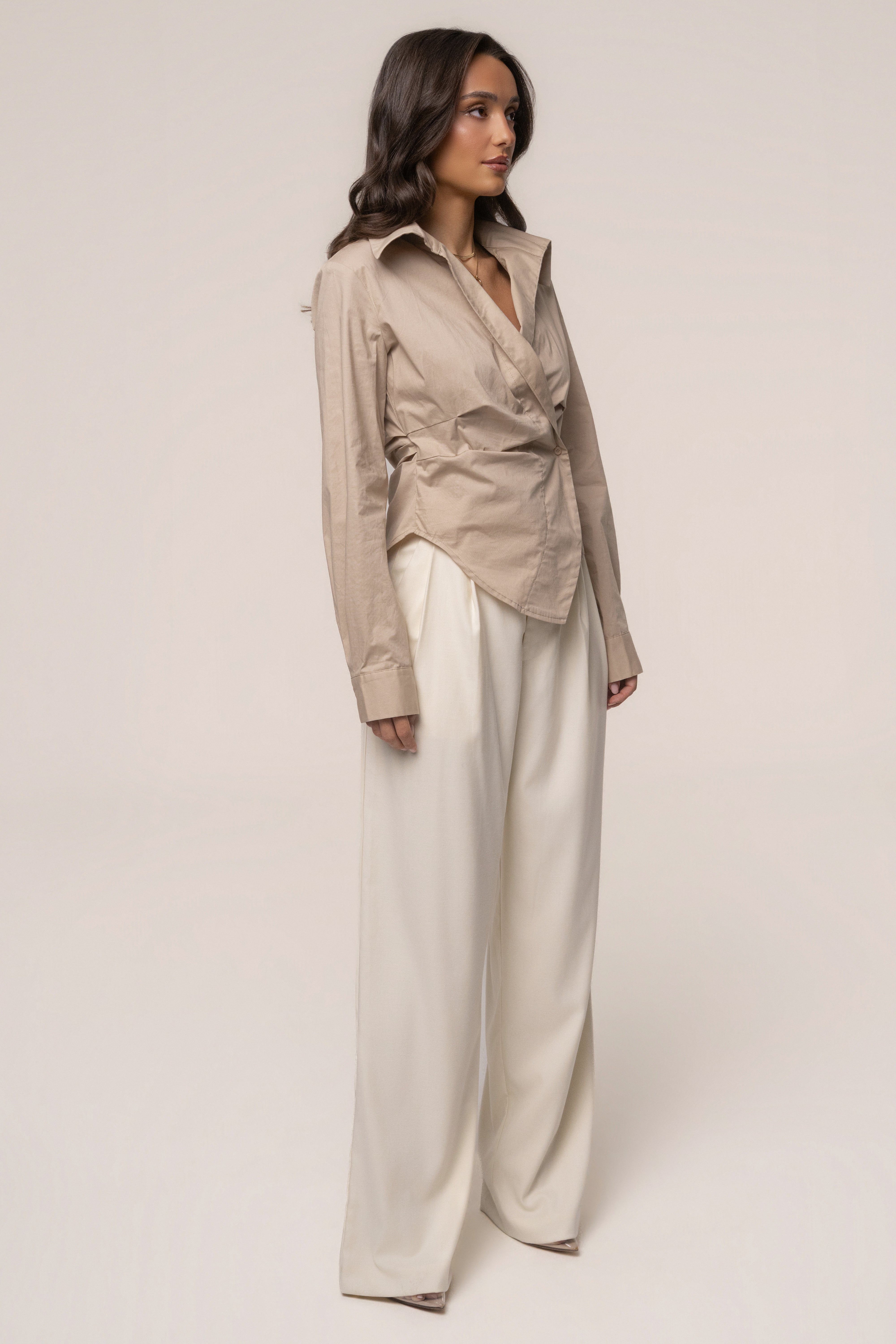 Beige Sculpt and Form blouse by JLUXLABEL, showcasing a stylish, fitted top with sculpting details and a smooth fabric finish.