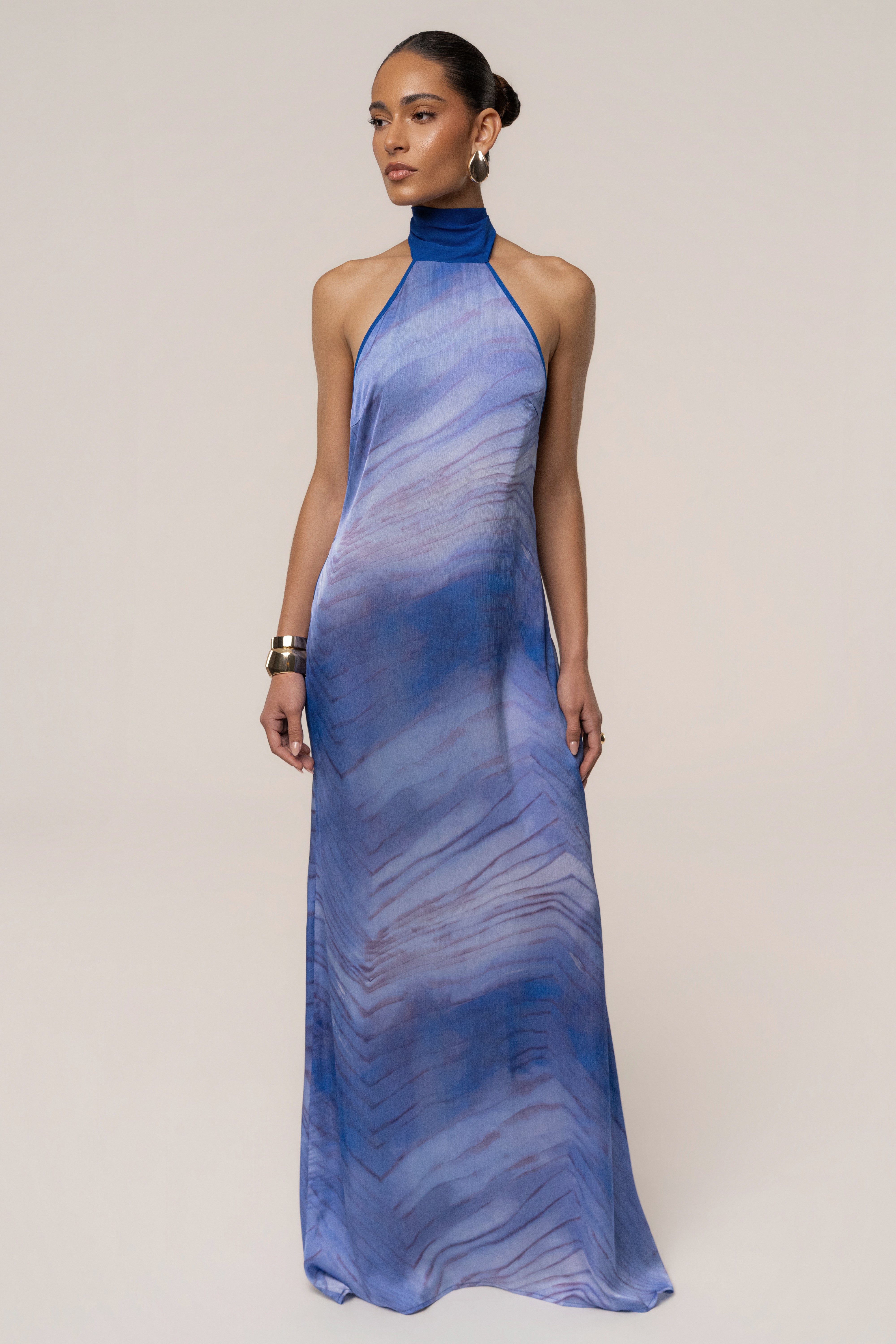 Blue Sunset Waves Maxi Dress by JLUXLABEL featuring flowing fabric and vibrant wave-inspired pattern.