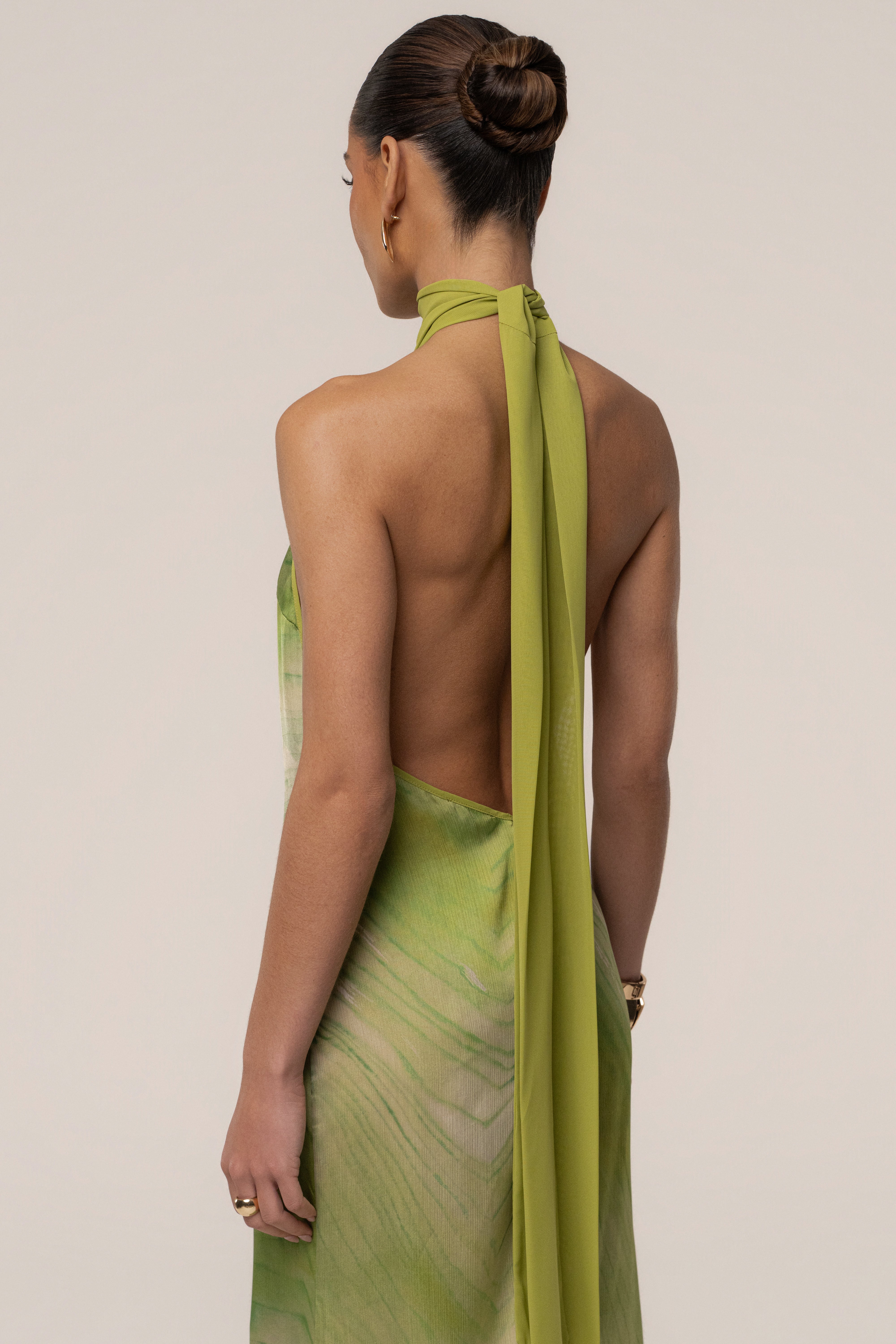 Green sunset waves maxi dress by JLUXLABEL featuring a flowing fabric and vibrant wave pattern for a stylish summer look.