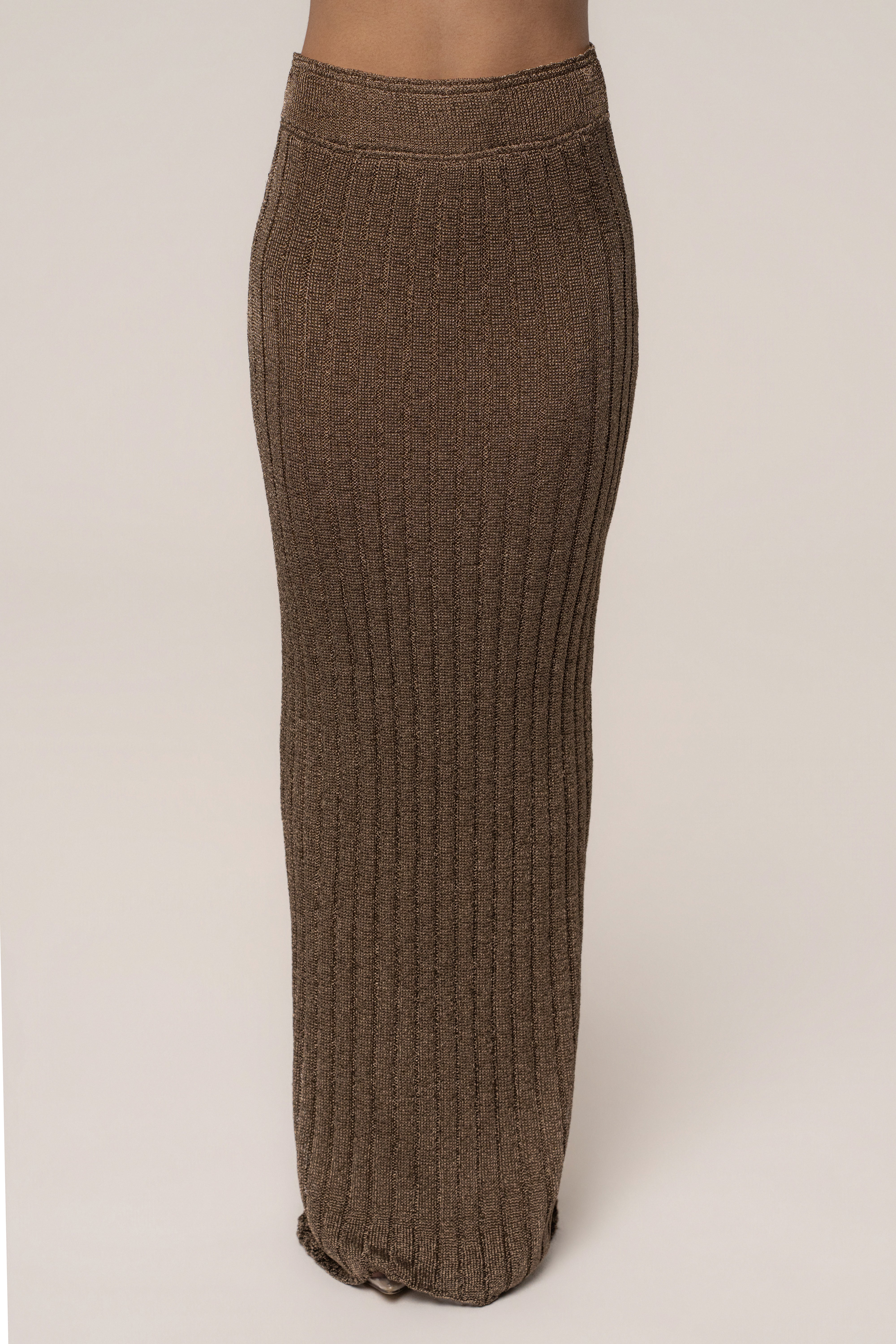 Bronze metallic maxi skirt from JLUXLABEL's resort collection, flowing fabric, high waist, styled for elegant summer looks.
