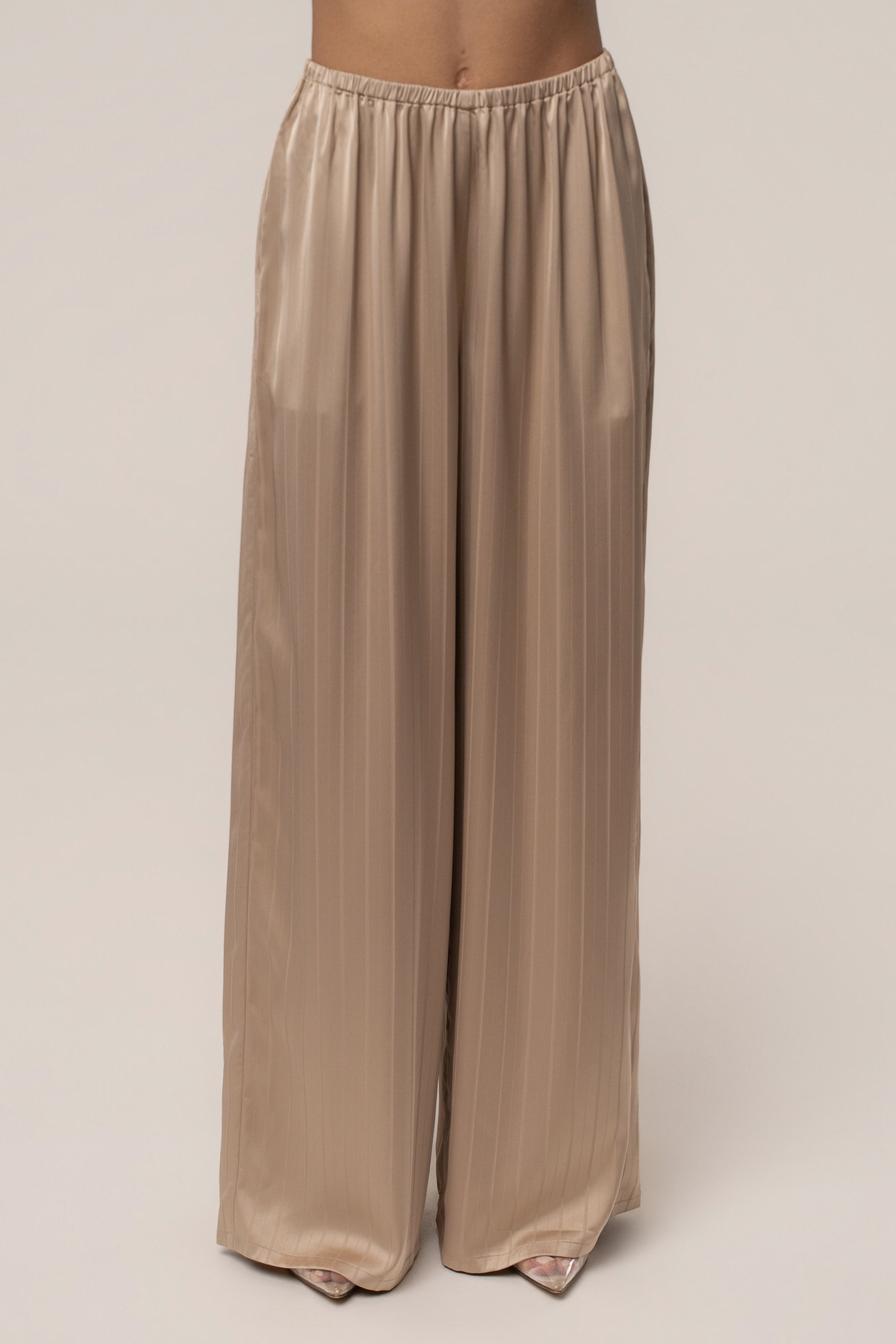 JLUXLABEL Stone The Standard Pant bottoms in neutral fabric, featuring a relaxed fit and stylish design, shown on a model.