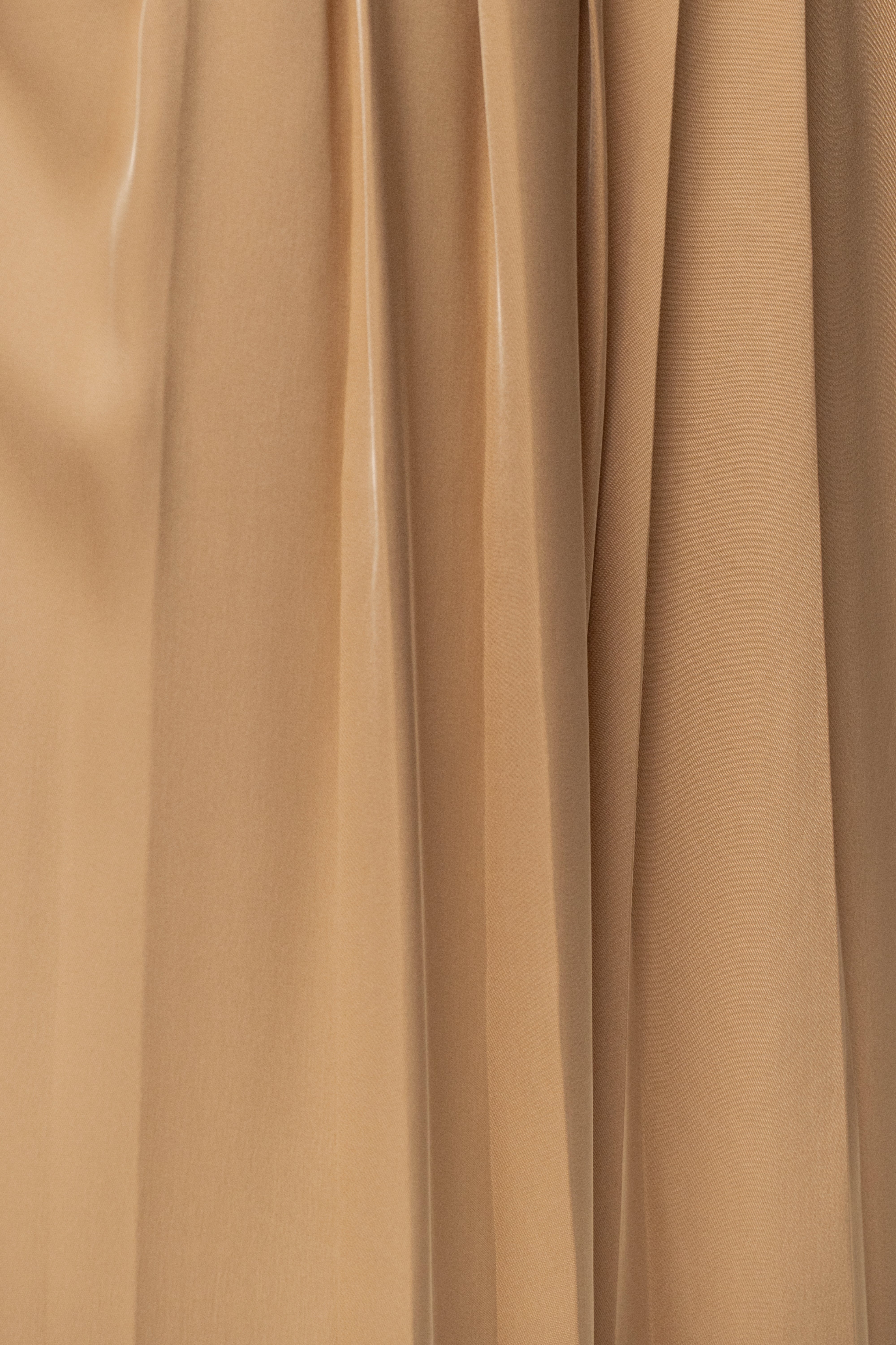 Beige Clara wide-leg pleated trousers by JLUXLABEL, featuring a relaxed fit and stylish pleats, shown on a model.