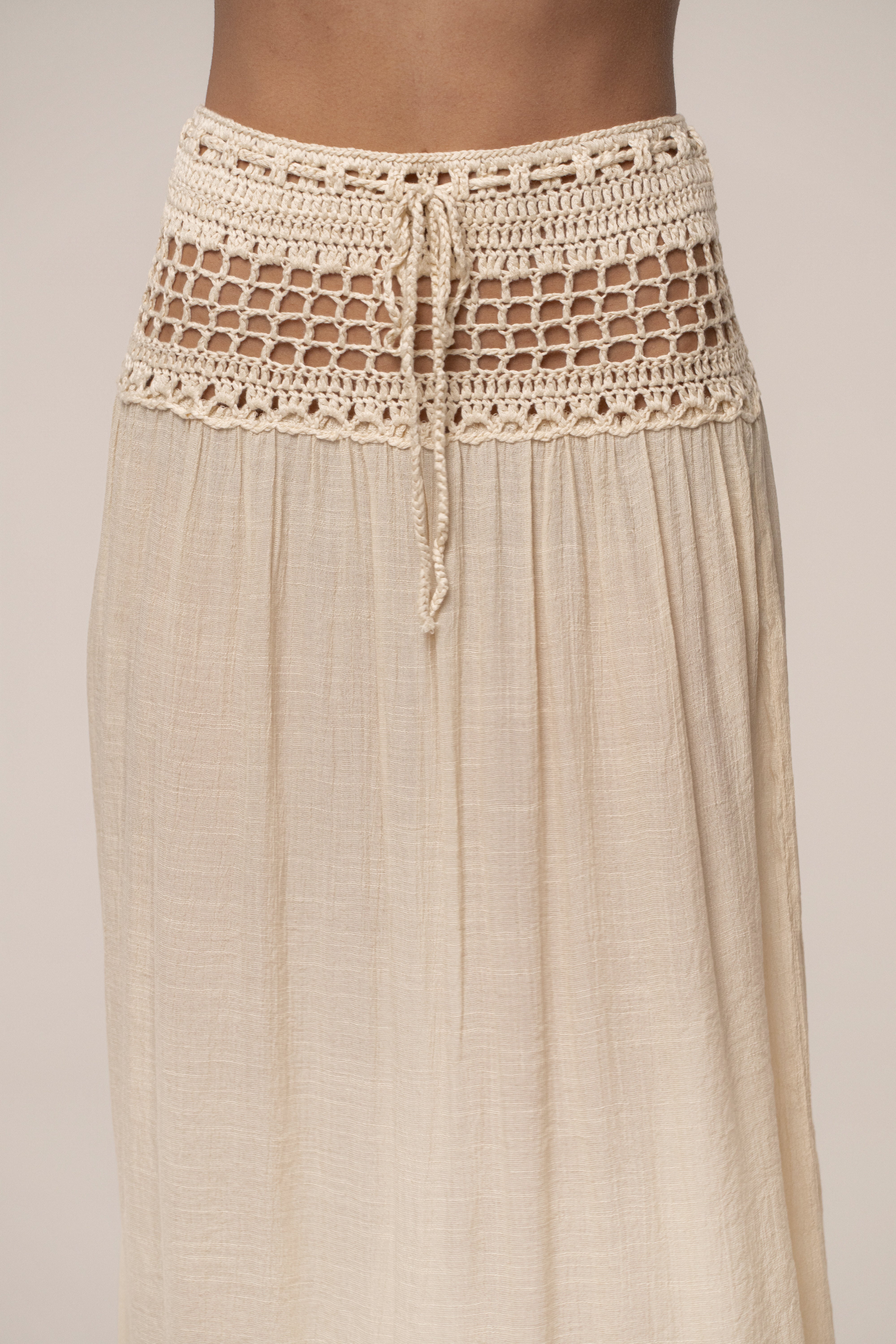 Beige JLUXLABEL crochet maxi skirt with resort style, flowing design, and intricate crochet detailing, perfect for warm-weather wear.