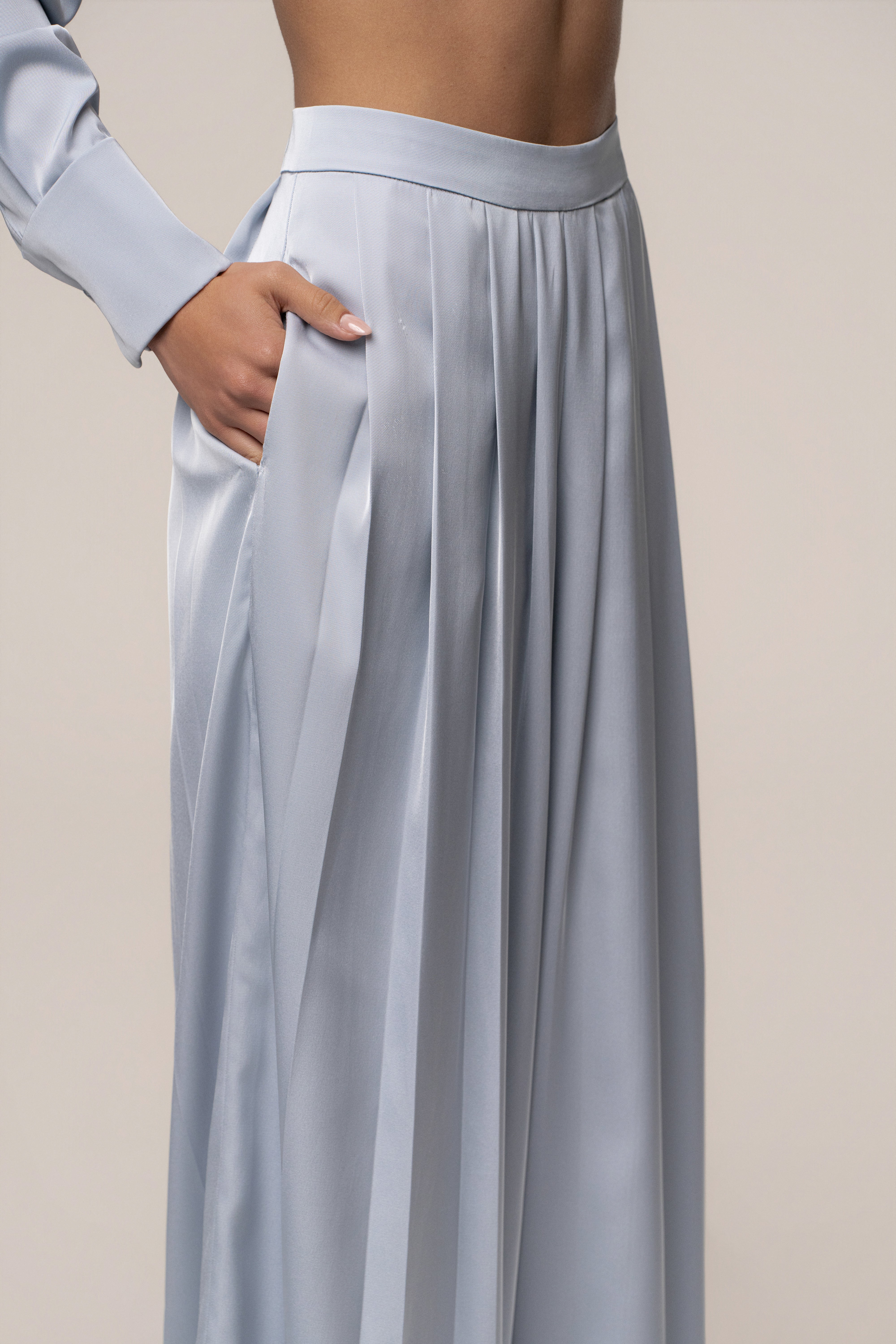 Blue Clara wide leg pleated trousers from JLUXLABEL, showcasing the stylish, flowy design and tailored fit of the bottoms.