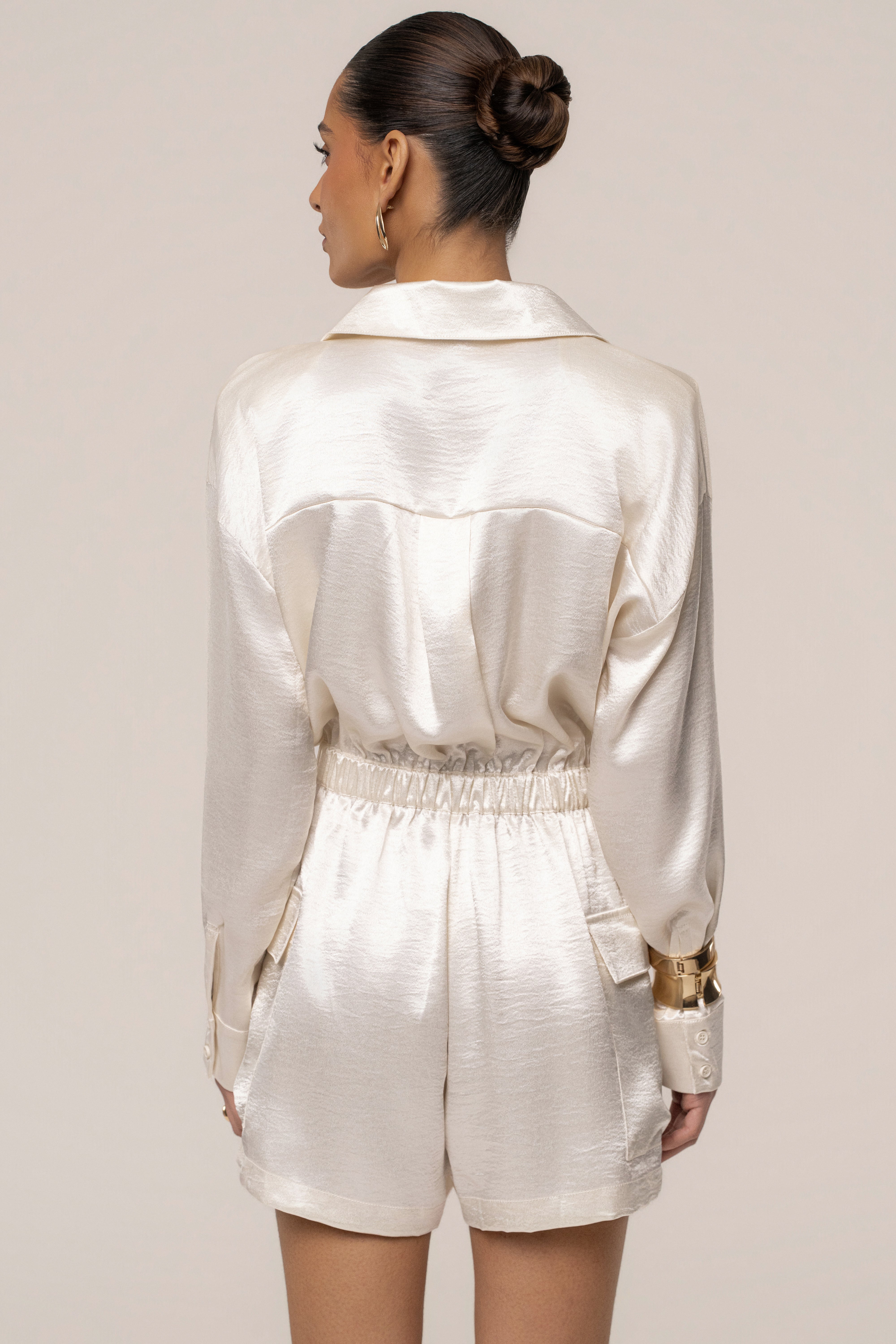 Ivory City Shine metallic romper by JLUXLABEL, featuring a sleek jumpsuit design with shiny, reflective fabric and modern style.