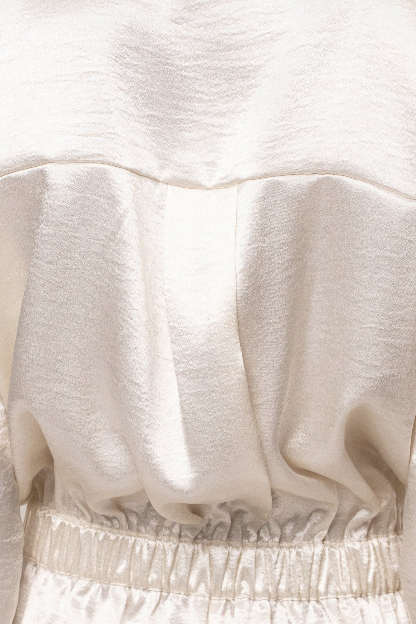 Ivory City Shine Metallic Romper by JLUXLABEL, featuring a shiny metallic finish with a stylish jumpsuit design and sleeveless cut.