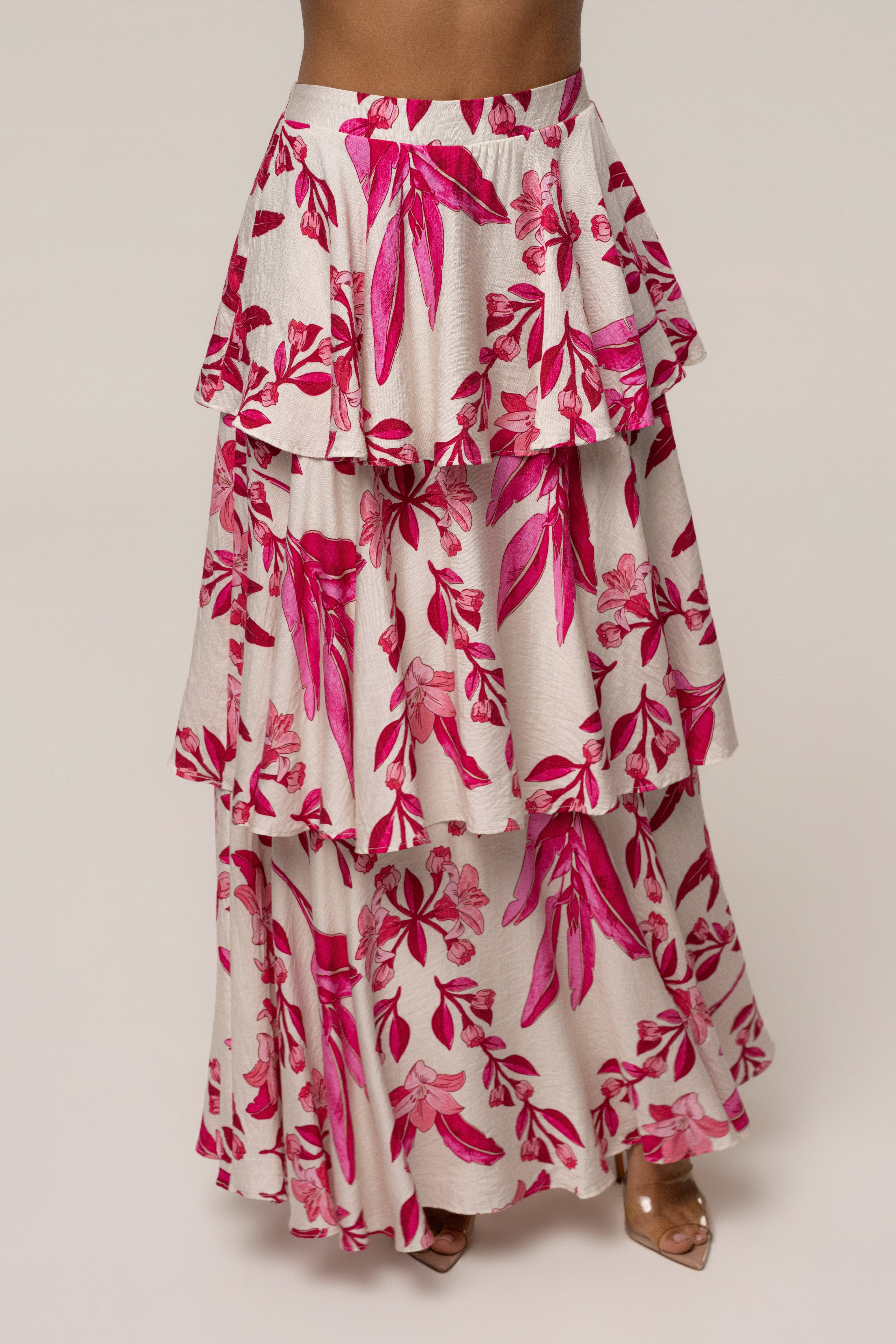 Pink floral Jasmine ruffle maxi skirt by JLUXLABEL, featuring a flowy design with ruffles and a floral print.