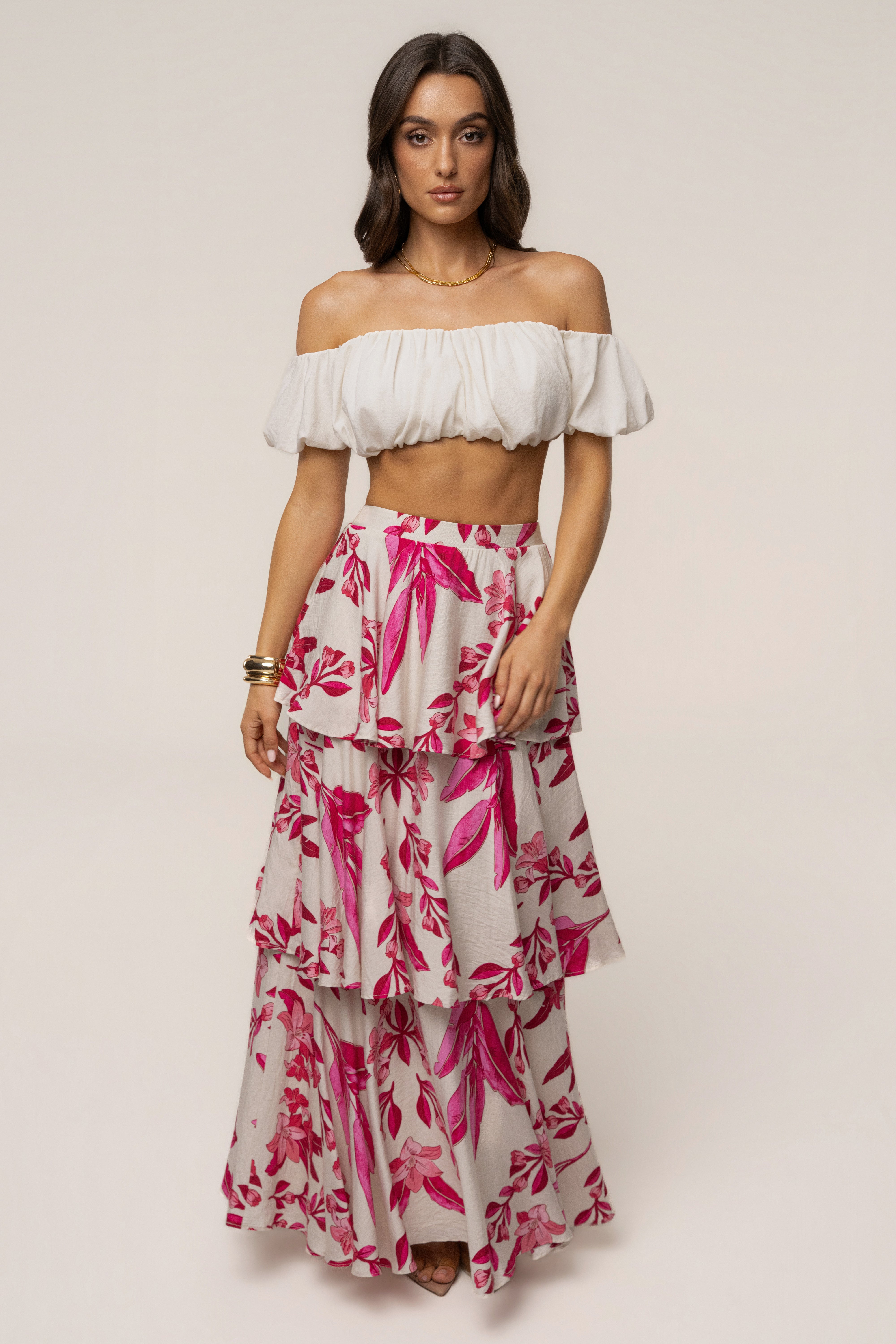 Pink floral Jasmine ruffle maxi skirt from JLUXLABEL, featuring a flowy design with floral patterns and ruffled hem.