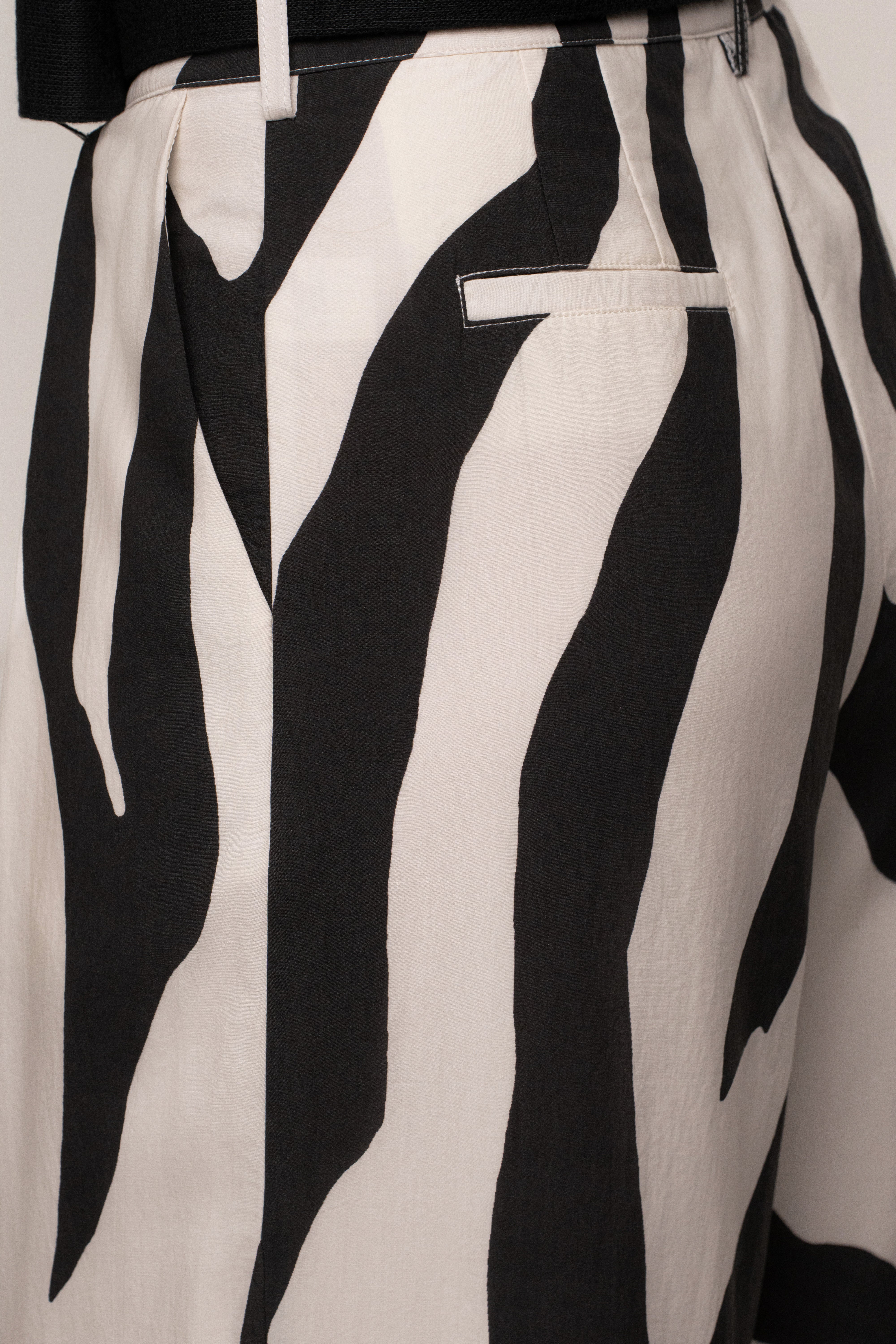 Black Zebra Prime trousers by JLUXLABEL, stylish bottoms with bold zebra print and tailored fit, shown on a model.