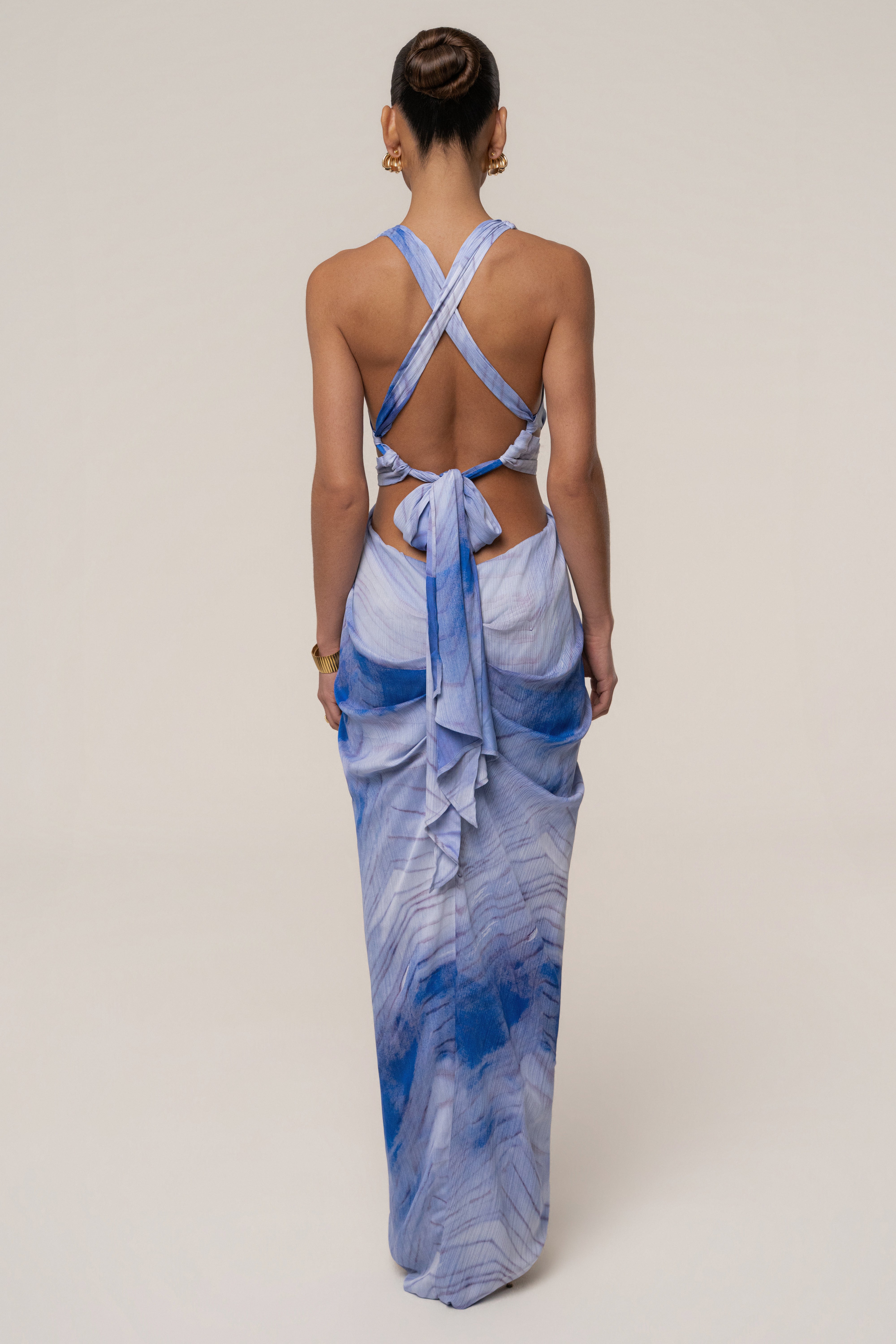 Blue Coastline Maxi Dress by JLUXLABEL showing flowing fabric and beach-inspired design on a model.