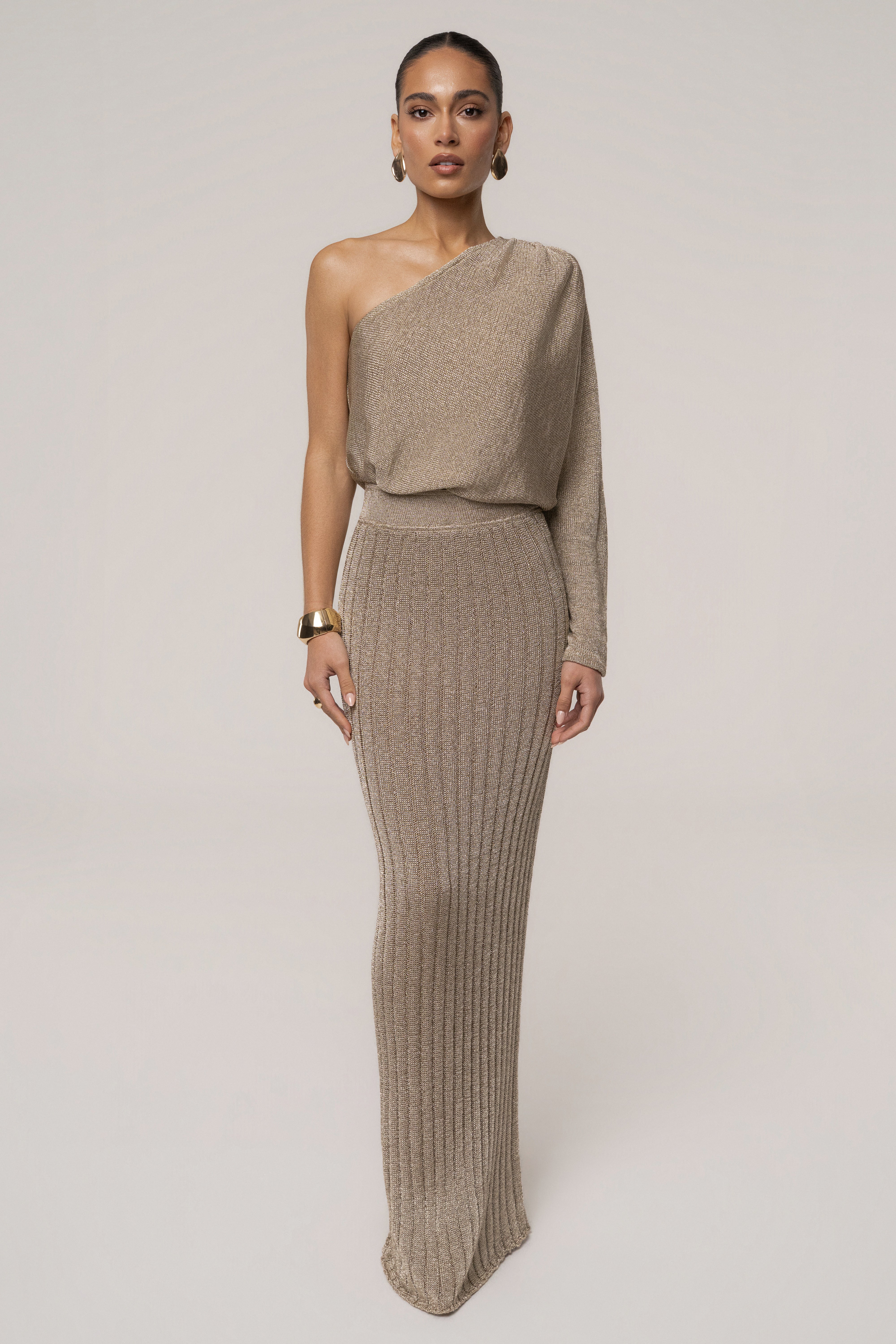 Gold metallic bodysuit from JLUXLABEL featuring a sleek, shiny finish and fitted design, perfect for stylish resort wear.