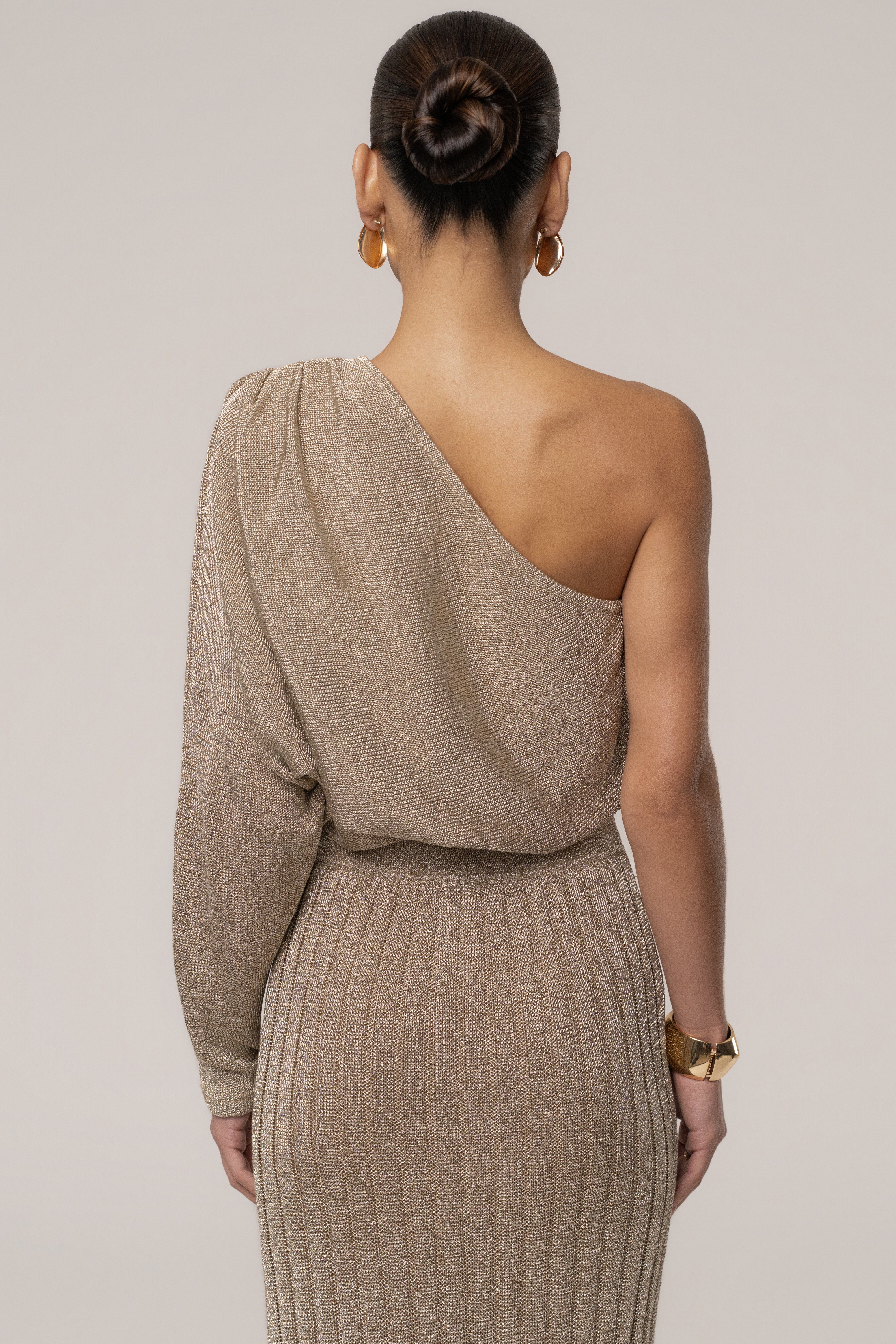 Gold metallic bodysuit by JLUXLABEL, featuring a shiny resort-style tops design with a fitted silhouette and sleeveless style.