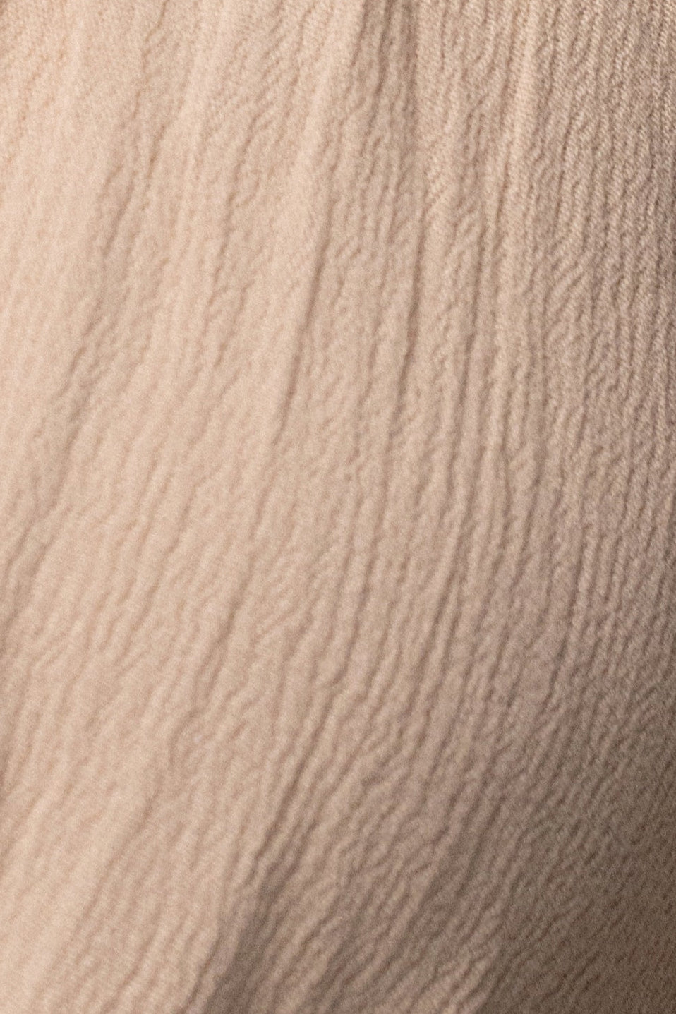 Beige Tulum drape top by JLUXLABEL featuring flowy fabric and relaxed fit, displayed on a hanger against a neutral background.