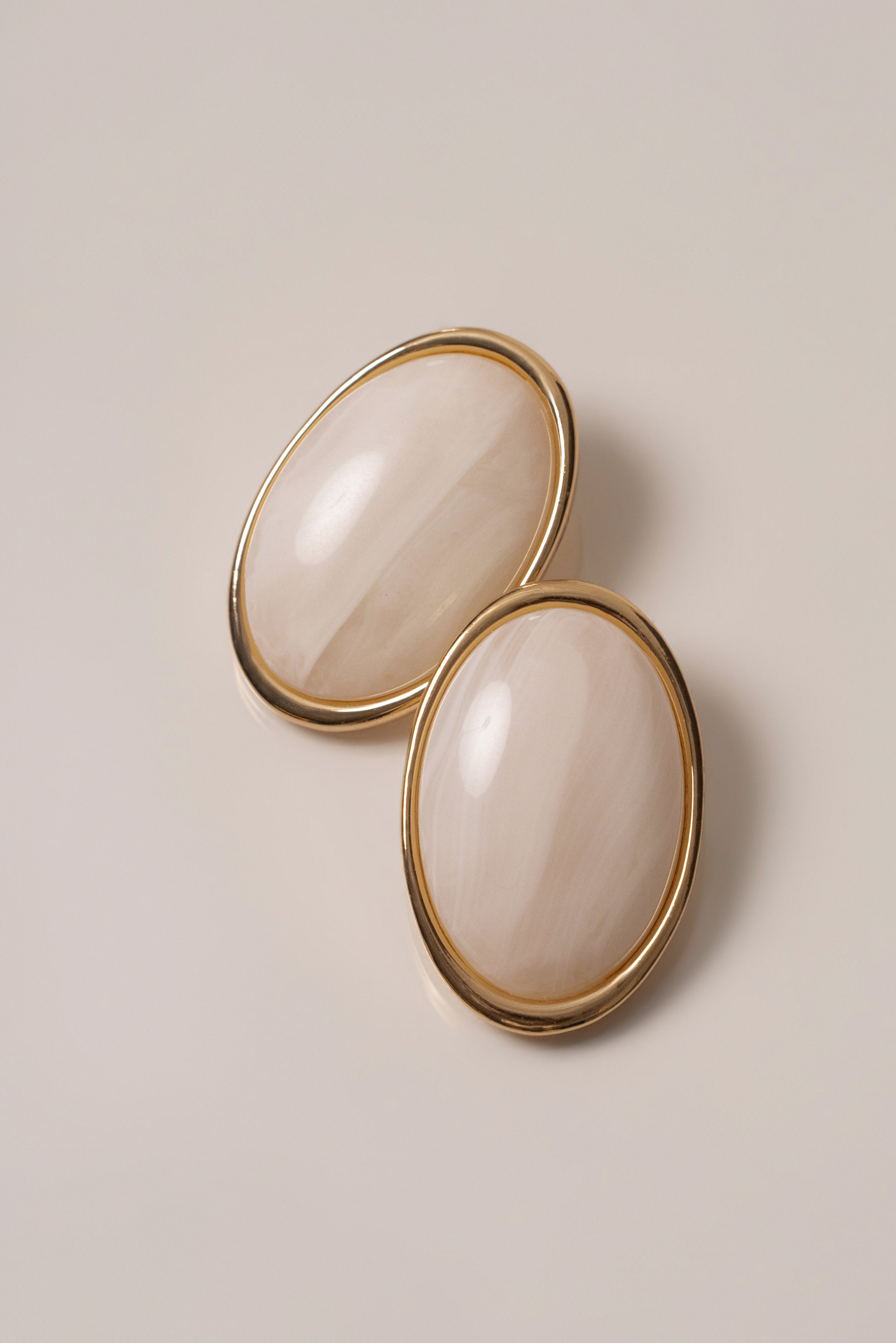 Ivory Alessia oval earrings by JLUXLABEL, elegant jewelry with smooth oval shape and gold-tone accents, close-up view.
