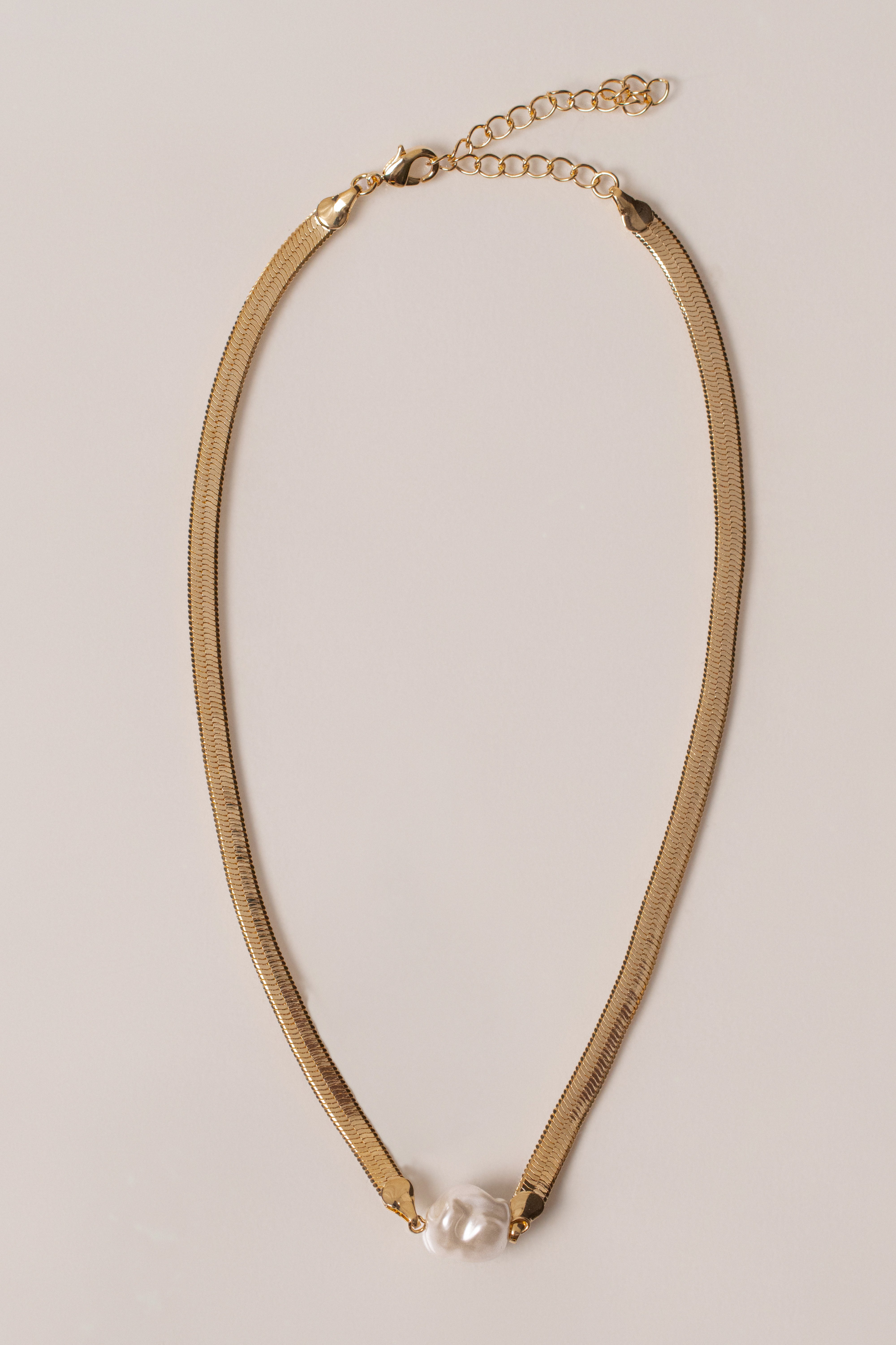 Gold pearl herringbone necklace from JLUXLABEL featuring a sleek, shiny chain with elegant pearl accents.