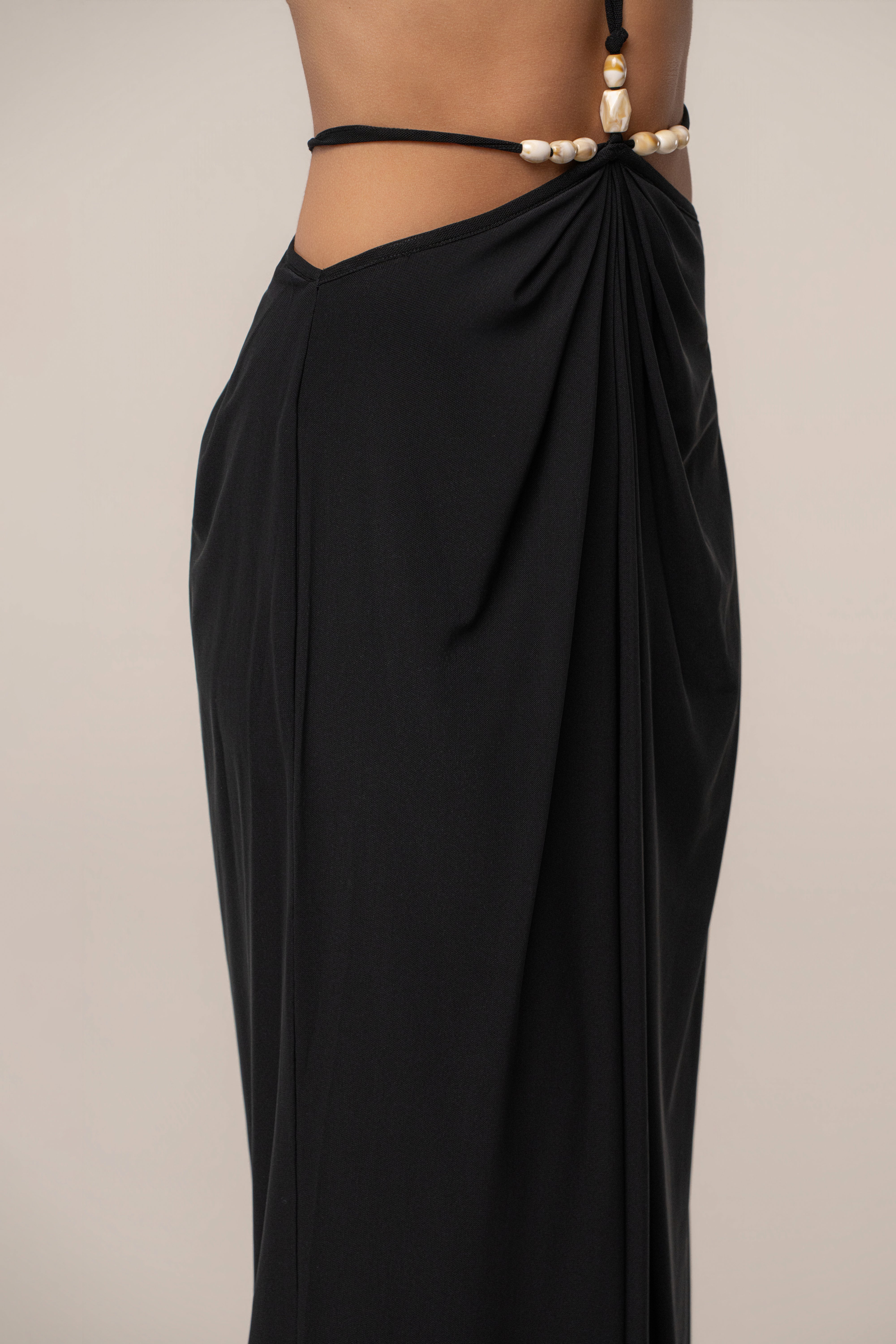 Black Hera Draped Maxi Skirt by JLUXLABEL, flowing fabric with draped design, full-length bottom worn with casual or dressy outfits.