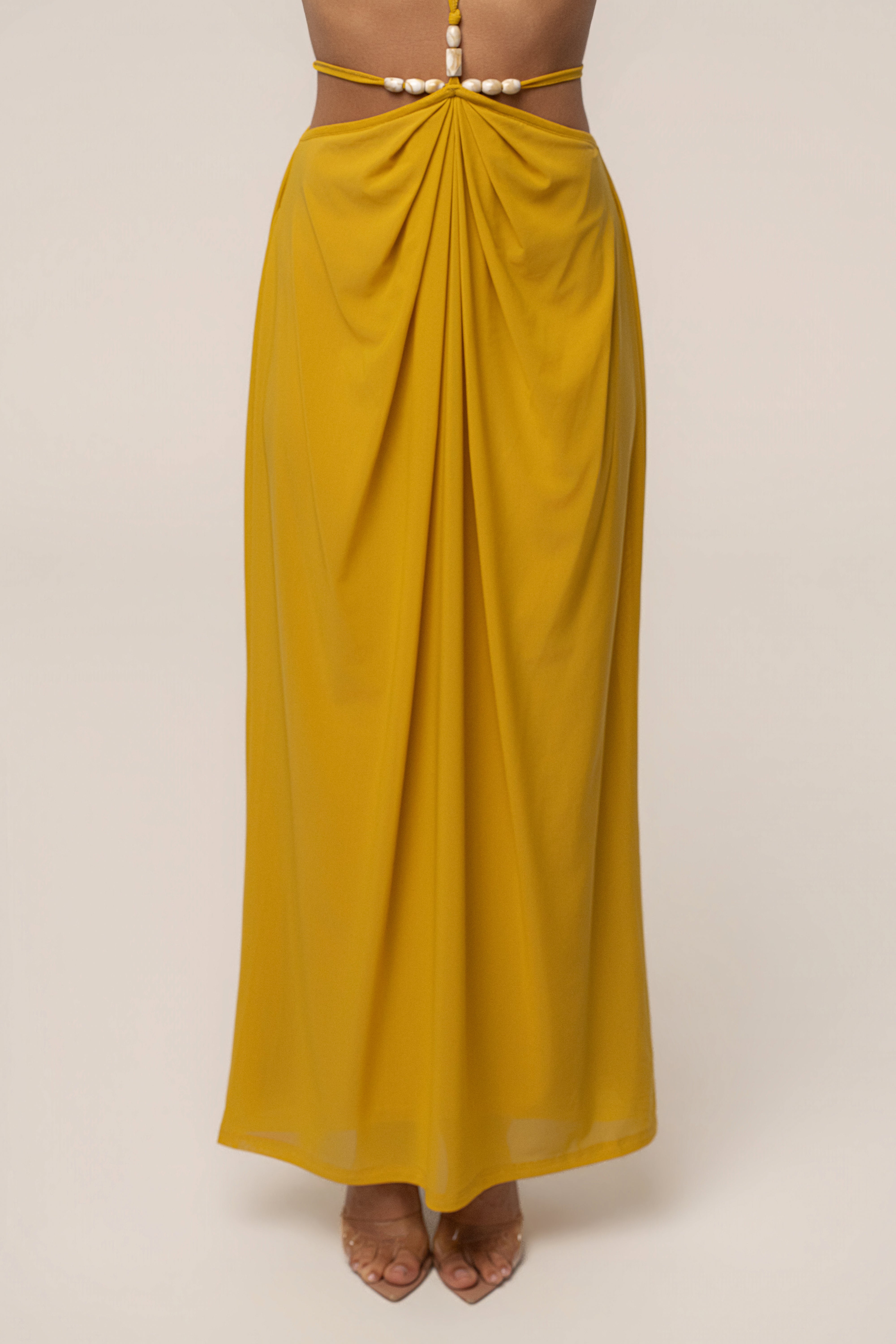 Mustard Hera draped maxi skirt by JLUXLABEL, flowing bottom with elegant drape and waist detail, styled as a fashionable women's bottoms.