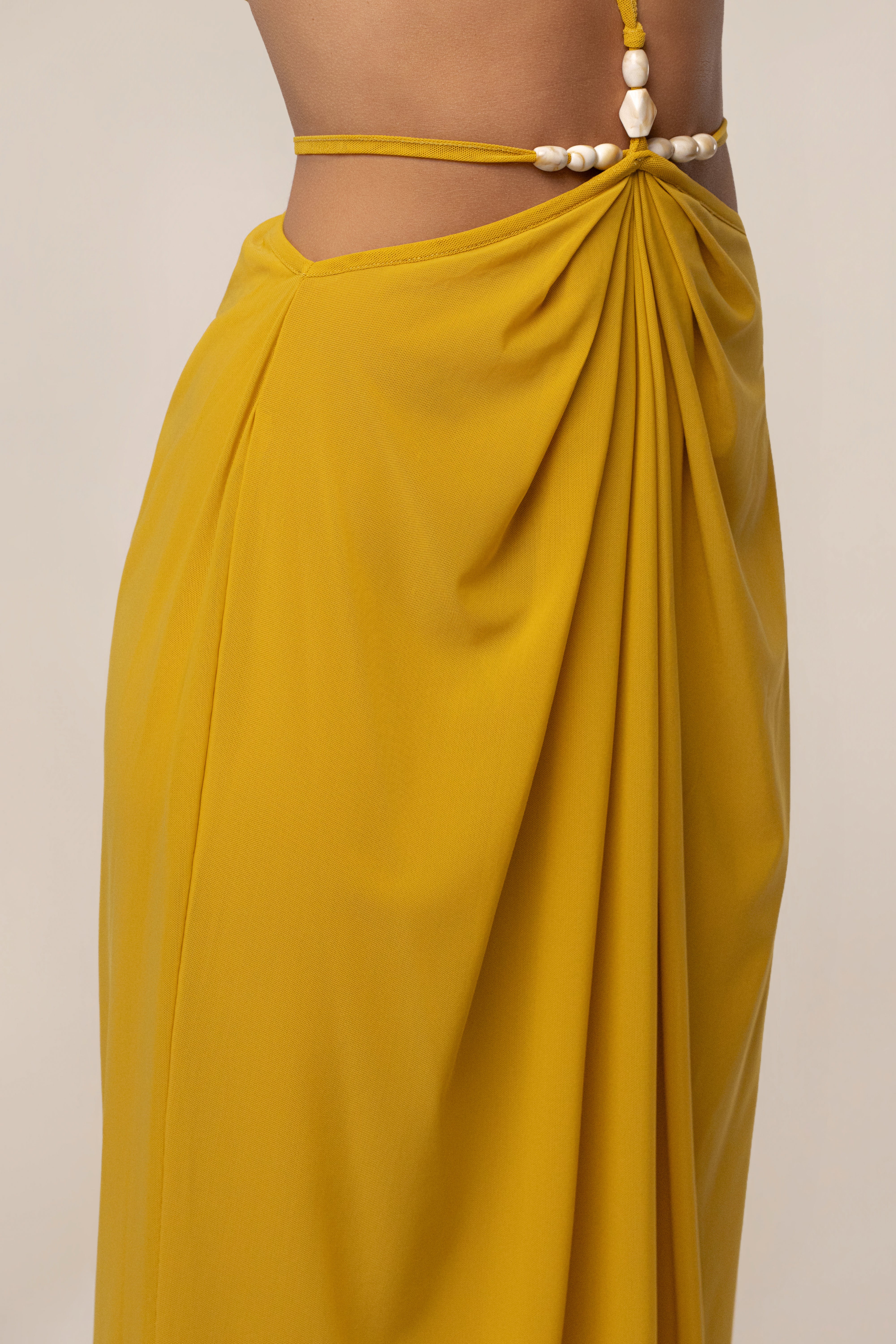 Mustard Hera draped maxi skirt by JLUXLABEL, flowing bottom with a stylish draped design, displayed on a model.