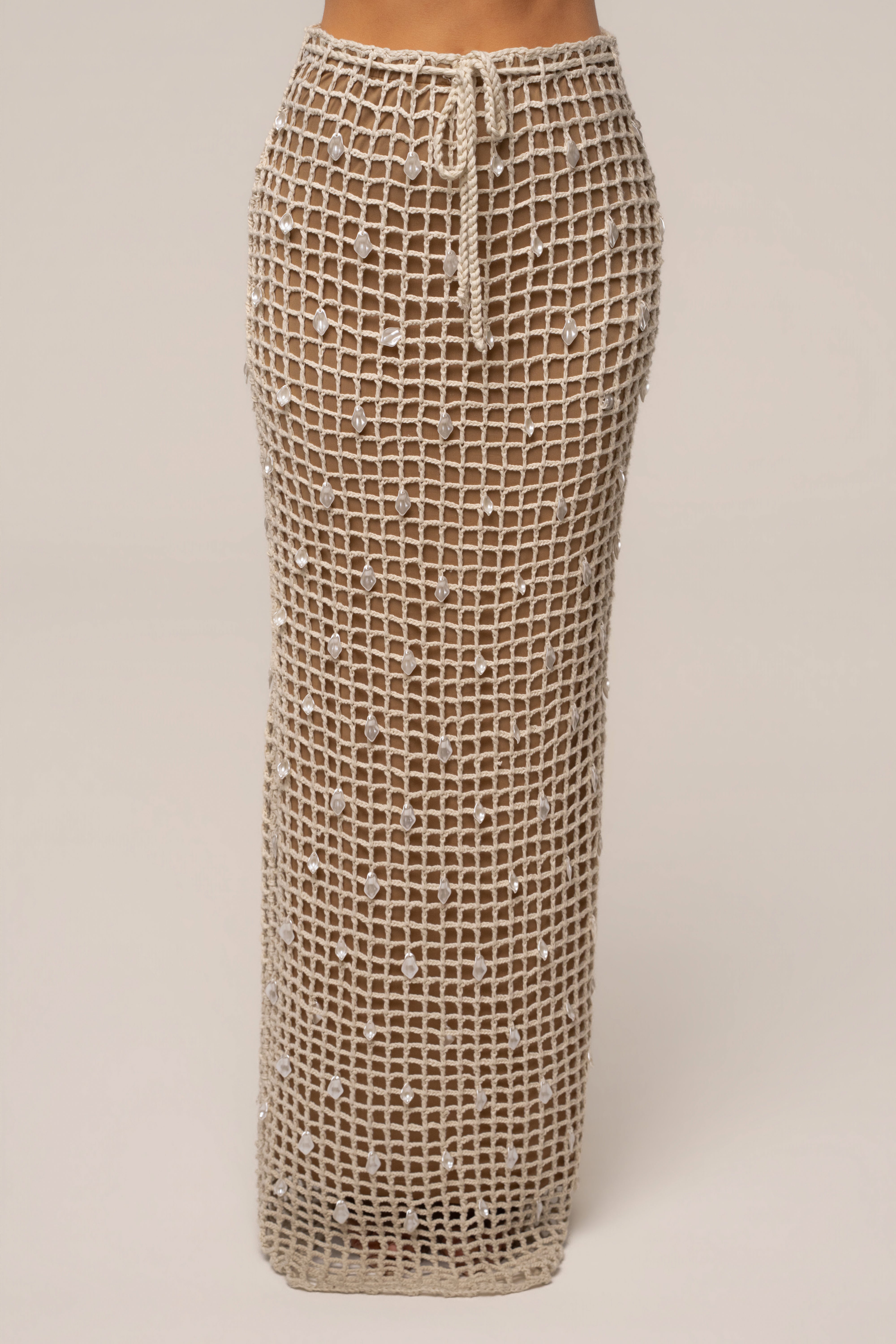 Ecru Pearl Shore crochet skirt by JLUXLABEL, showcasing intricate crochet details and a flowy, beachy style.