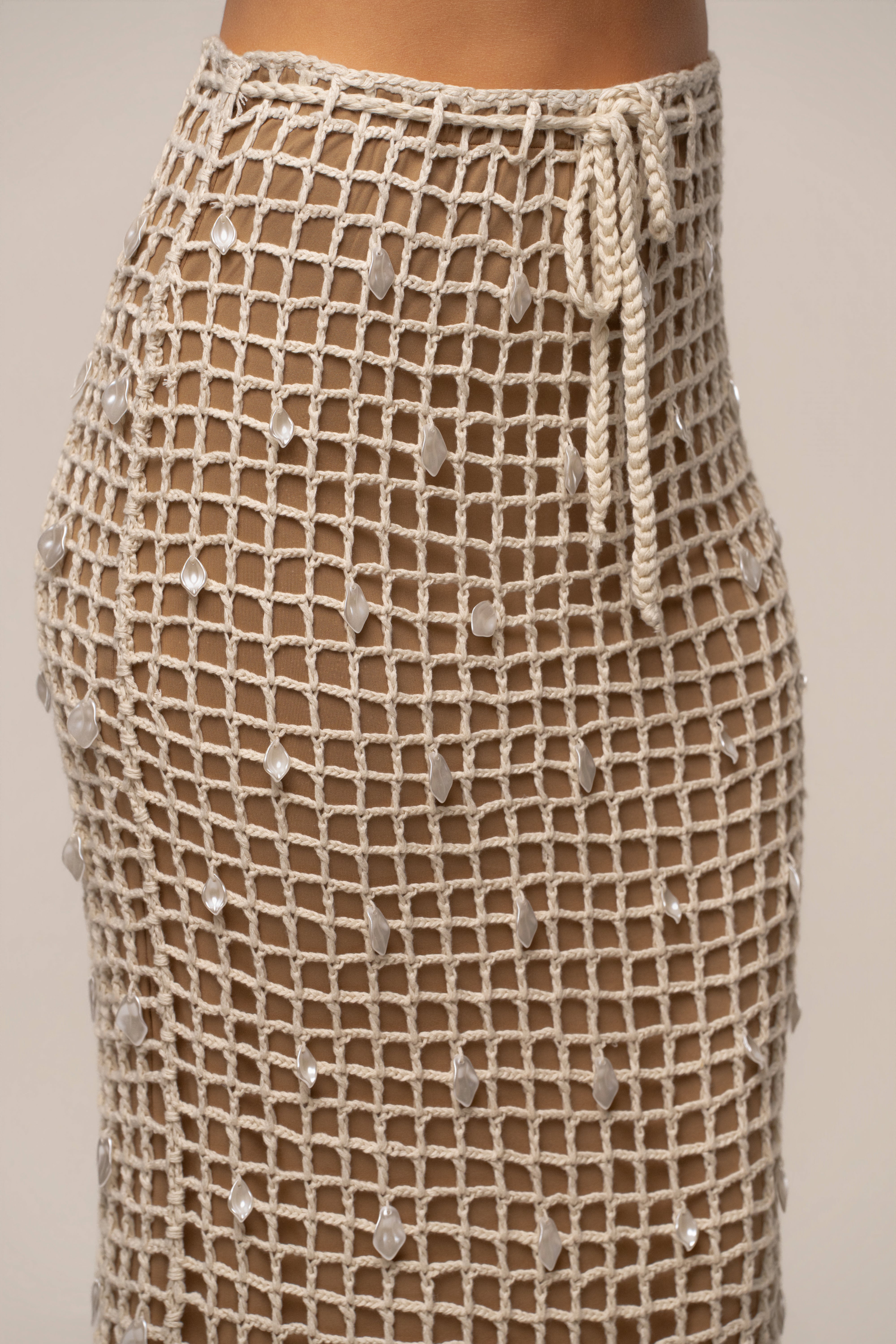 Ecru Pearl Shore crochet skirt by JLUXLABEL, featuring intricate crochet design and pearl accents, styled as a stylish bottom.