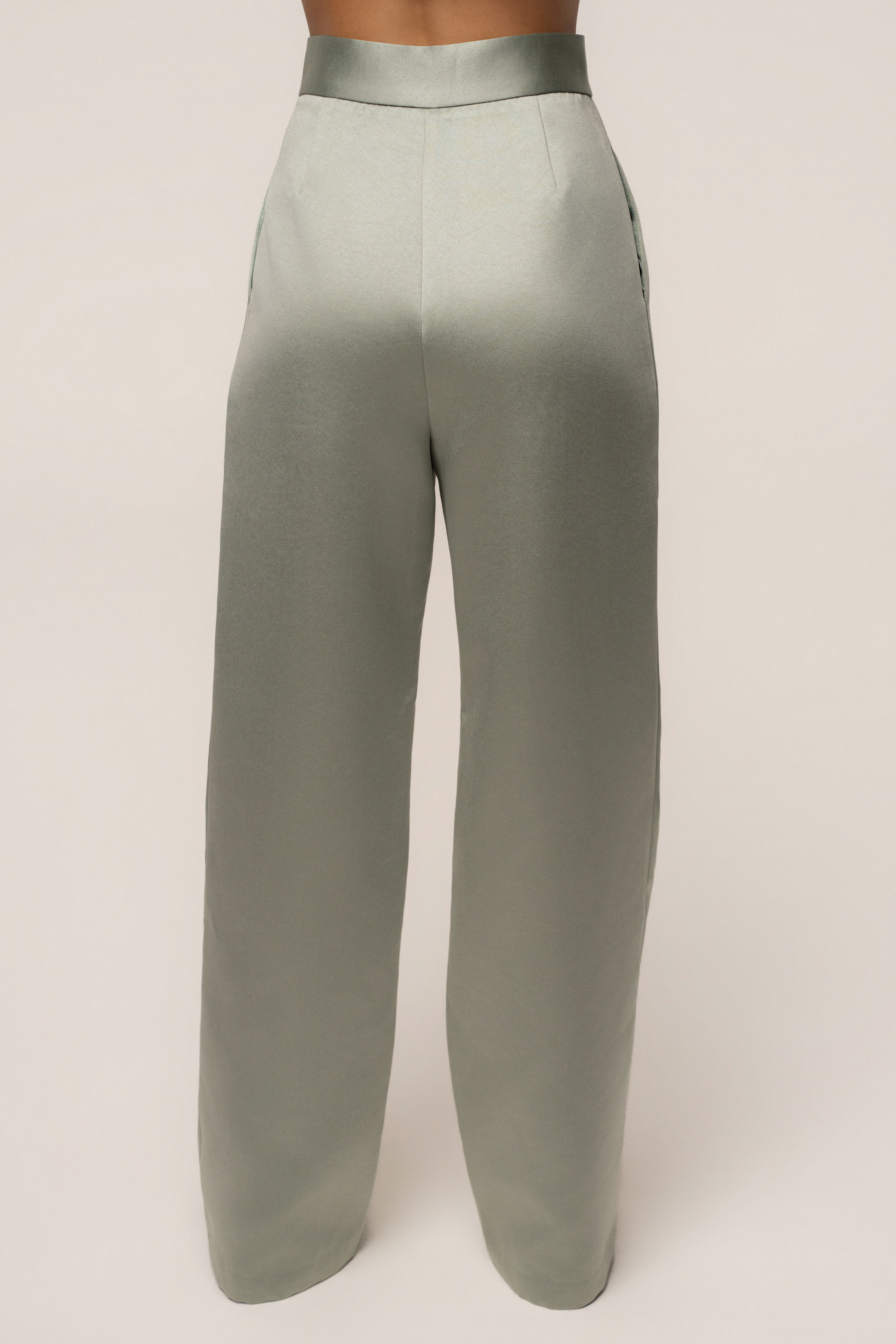 Sage City Nights satin trousers by JLUXLABEL featuring a relaxed fit and smooth satin fabric, styled with side pockets and a high waist