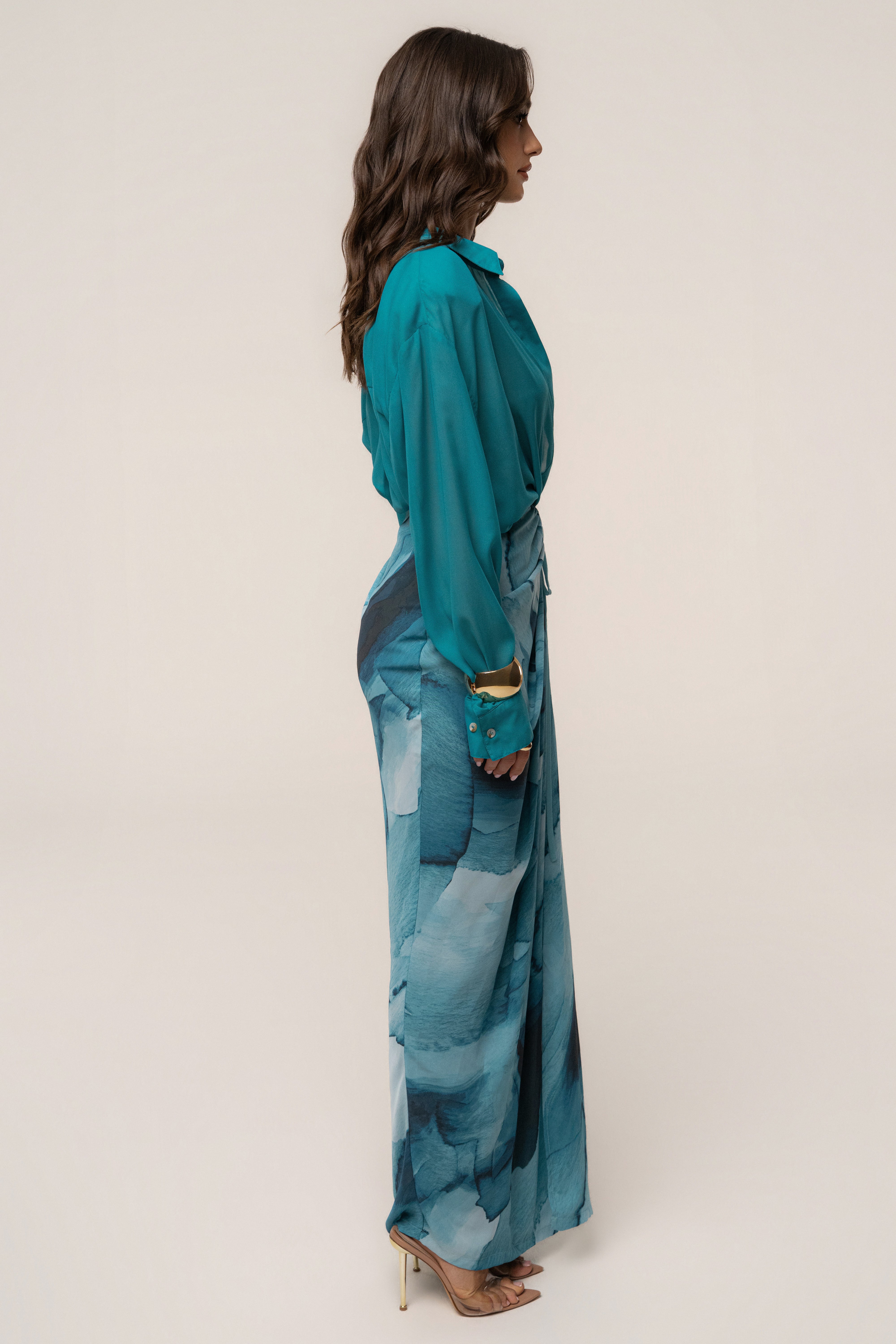 JLUXLABEL Aqua Fierce button-down shirt, a stylish top with vibrant aqua color and classic collar, displayed on a hanger.