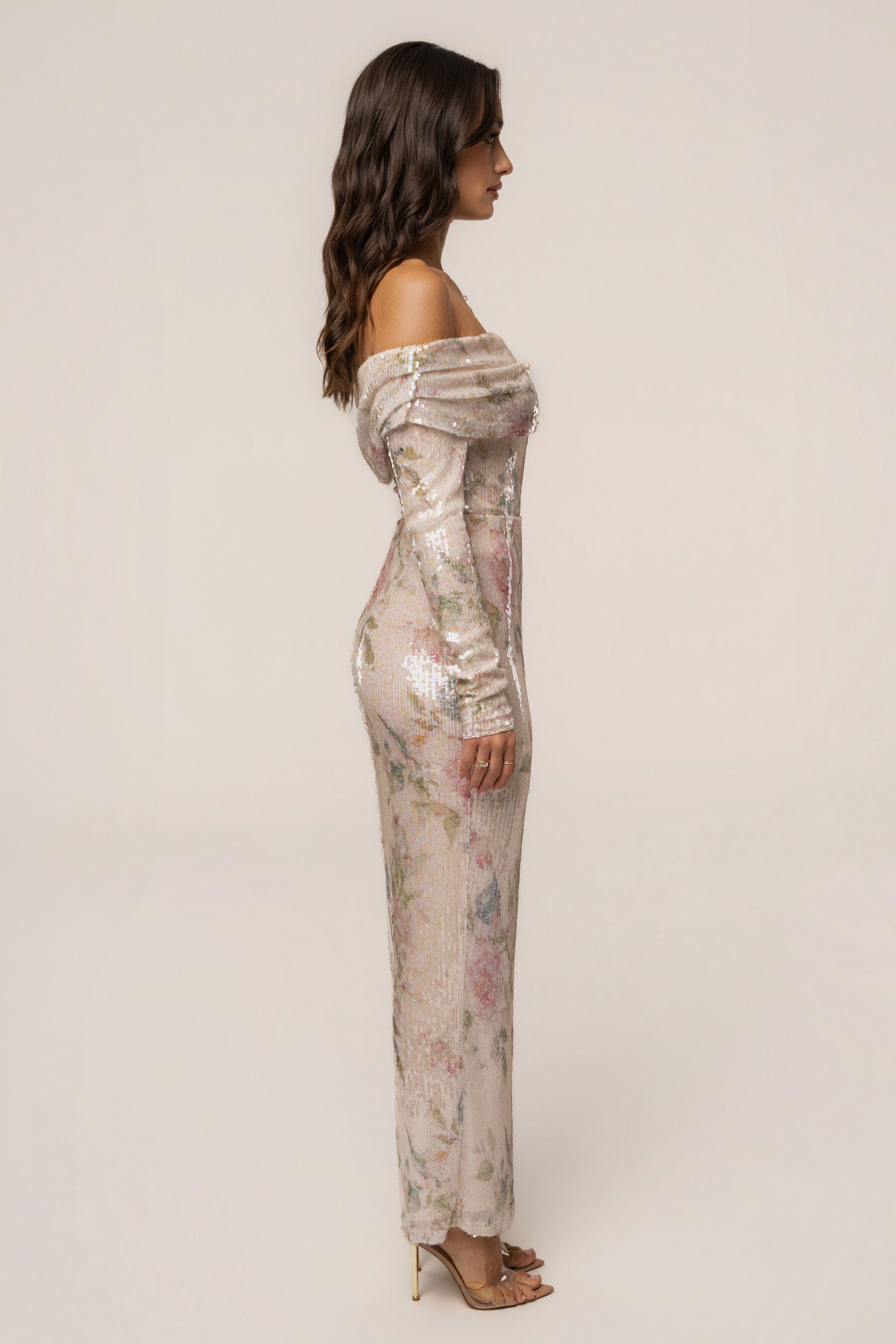Ivory floral Villa Nights sequin bodysuit by JLUXLABEL, with floral fabric and shimmering sequin details, styled as a fashionable top.