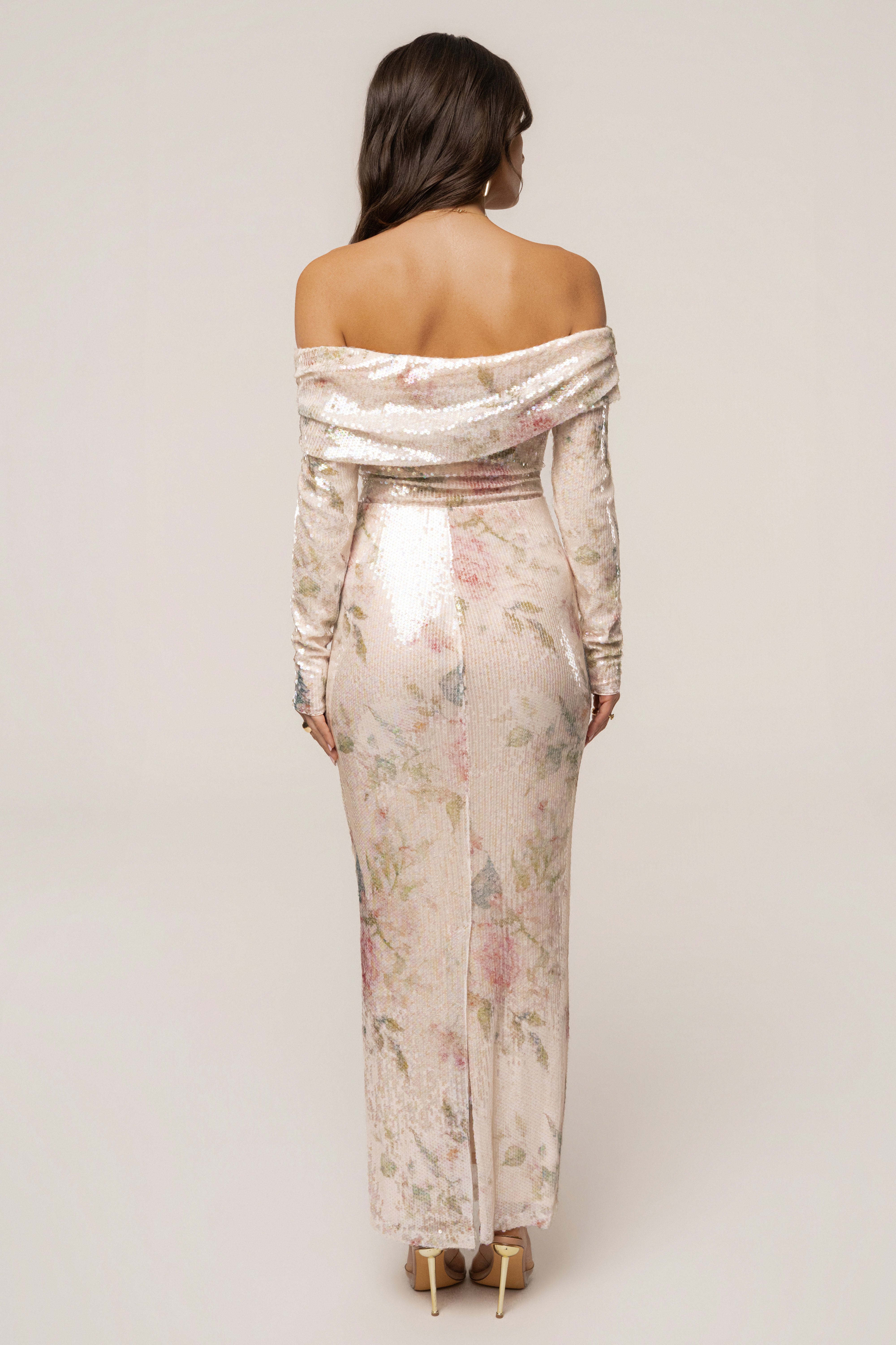 Ivory floral Villa Nights sequin bodysuit from JLUXLABEL, featuring floral details and shimmering sequins, styled as a fashionable top.