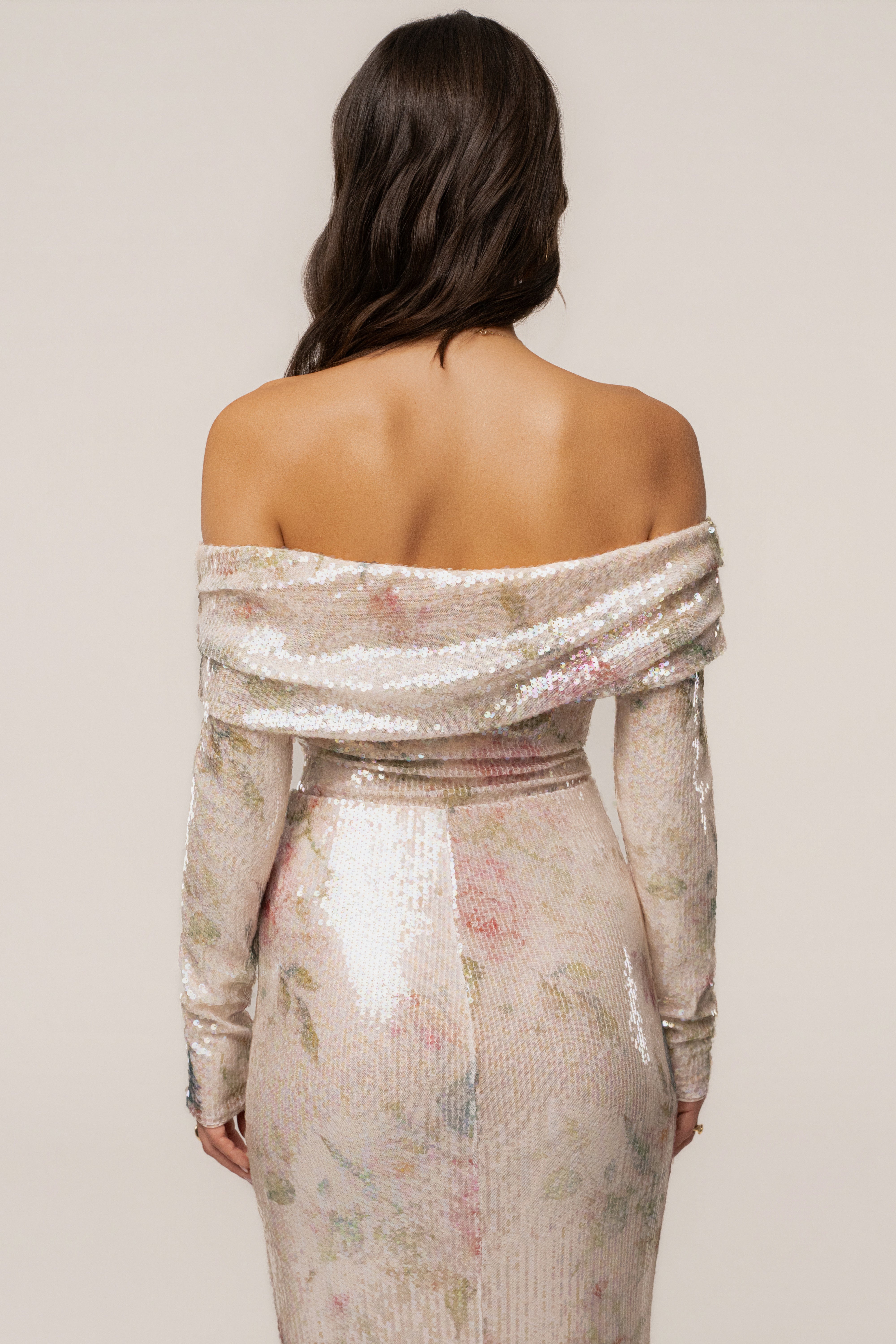 Ivory floral Villa Nights sequin bodysuit by JLUXLABEL, featuring floral embroidery and shimmering sequins, displayed on a hanger.