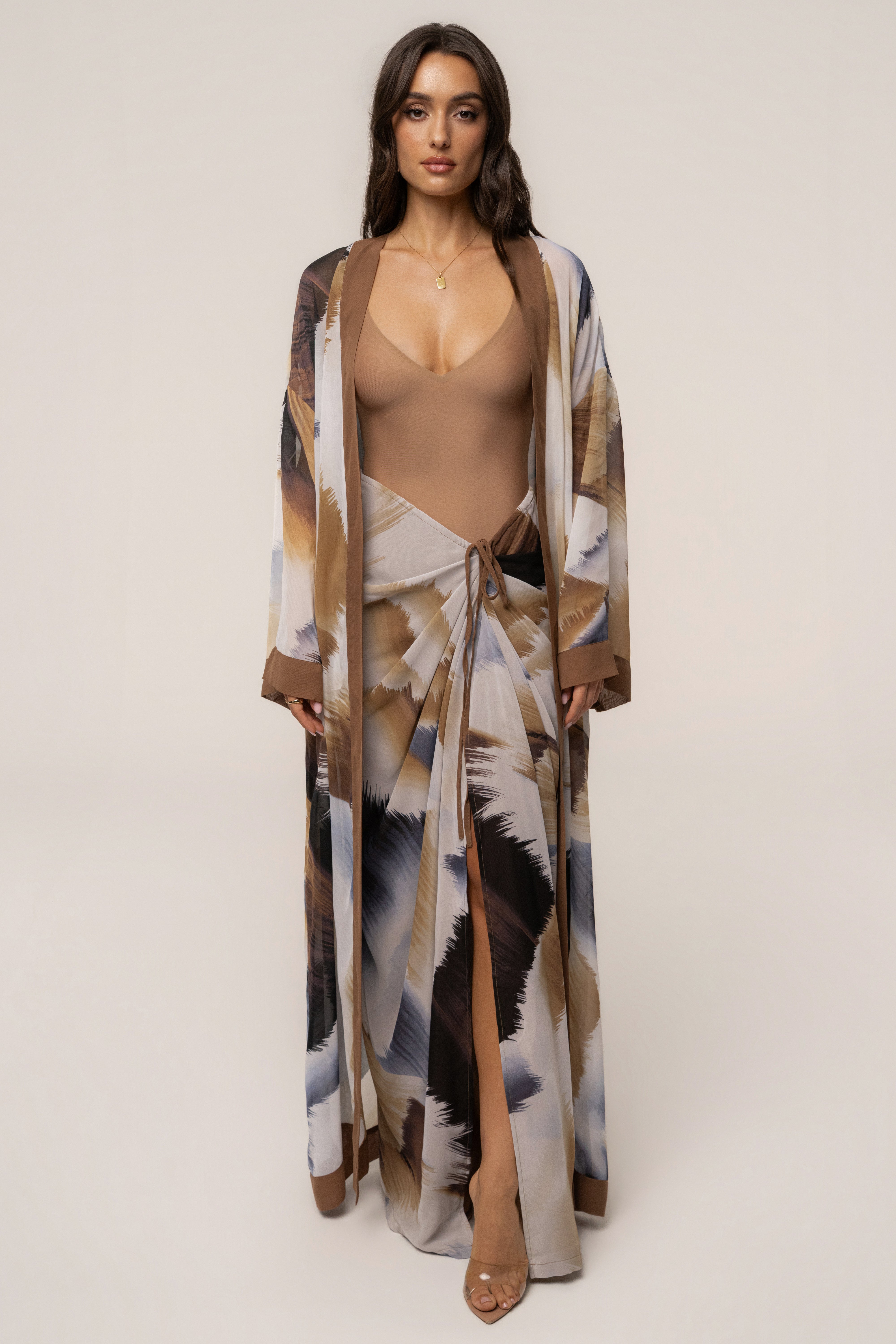 Brown abstract printed skirt from JLUXLABEL, stylish bottoms with a flowing design and Noelia pattern visible in the image.