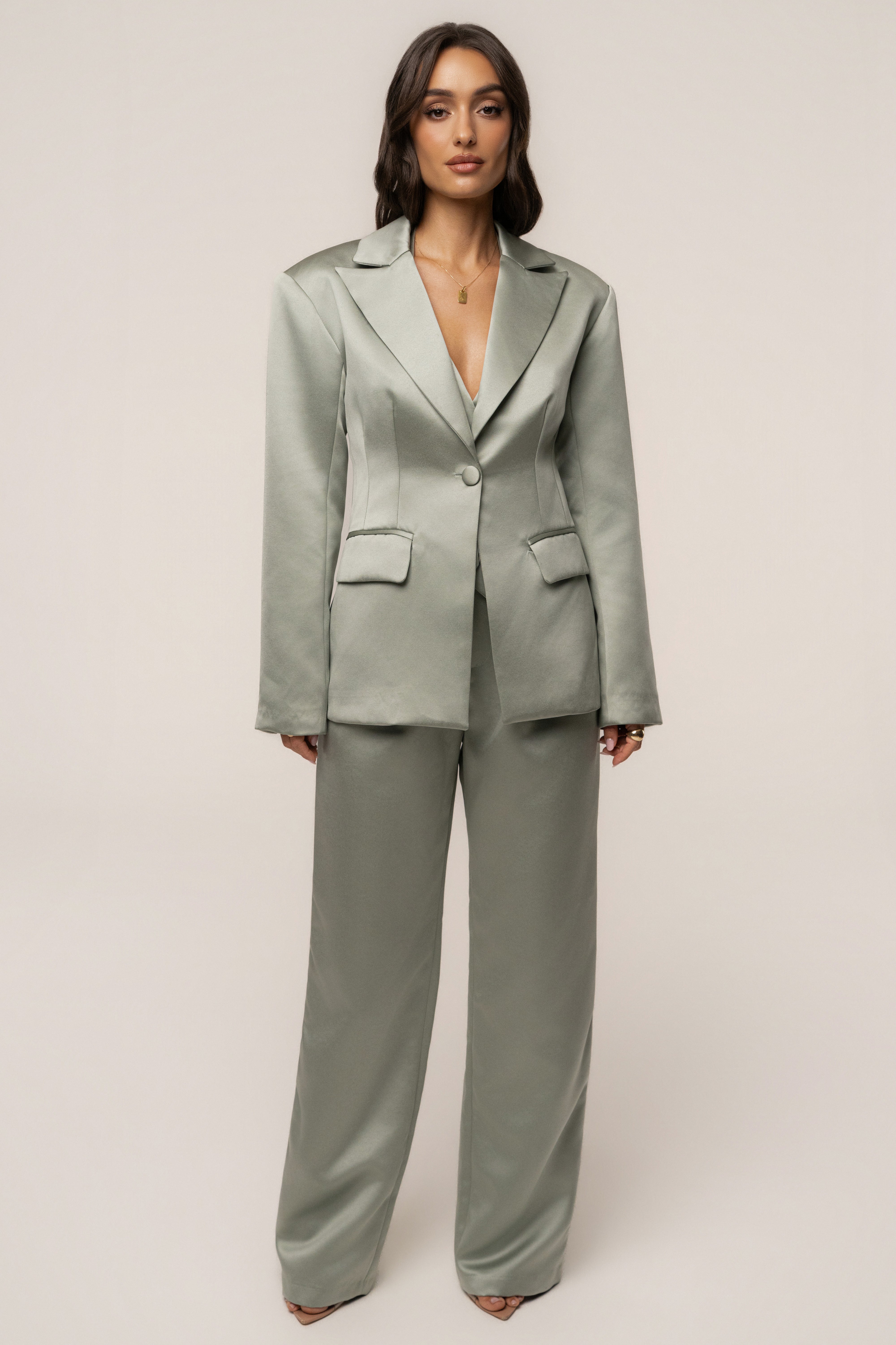 Sage City Nights satin trousers by JLUXLABEL displayed on a model, showing the relaxed fit and smooth satin fabric.