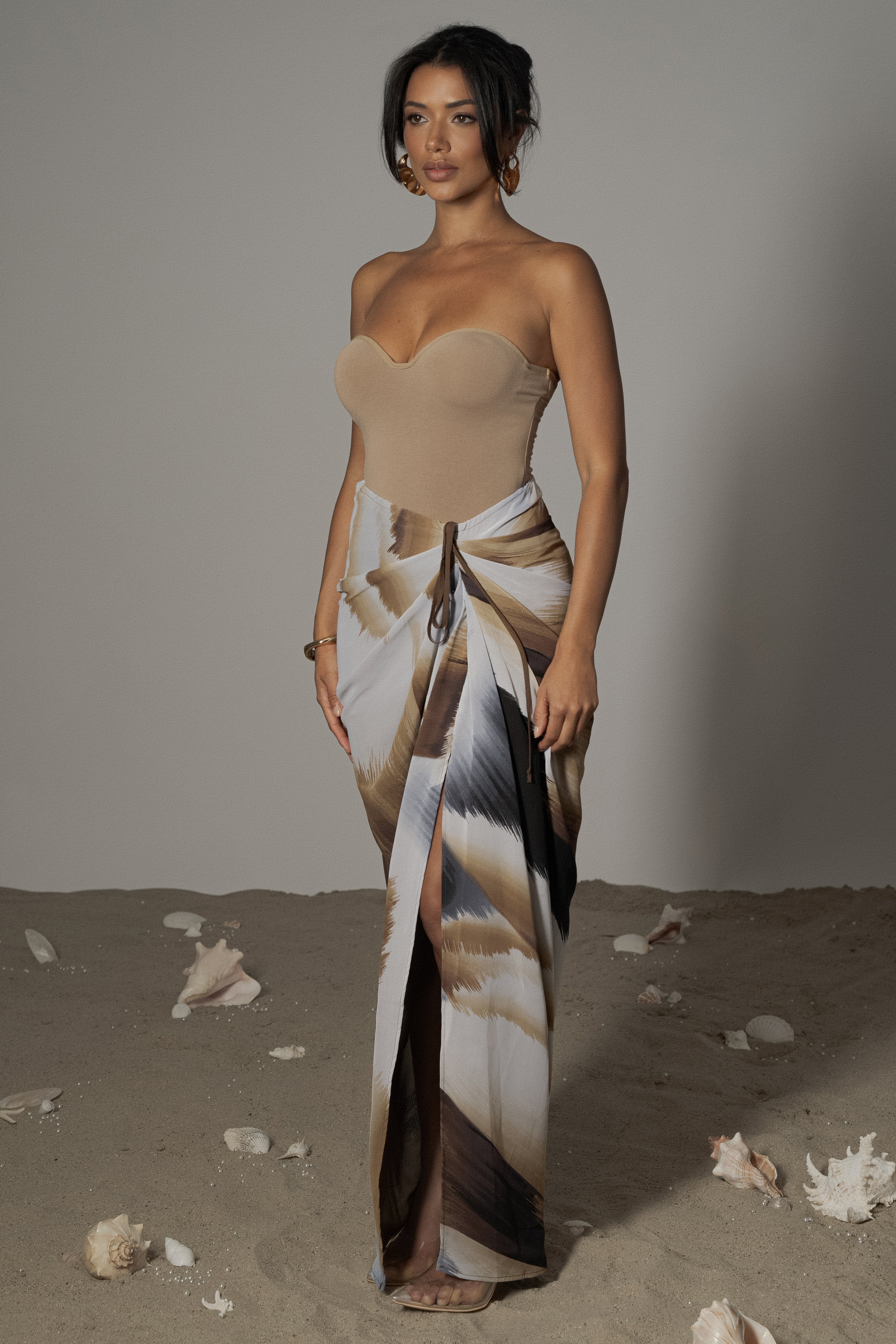 Brown abstract printed Noelia skirt by JLUXLABEL, showcasing its flowy fabric and stylish design as a fashionable bottoms piece.